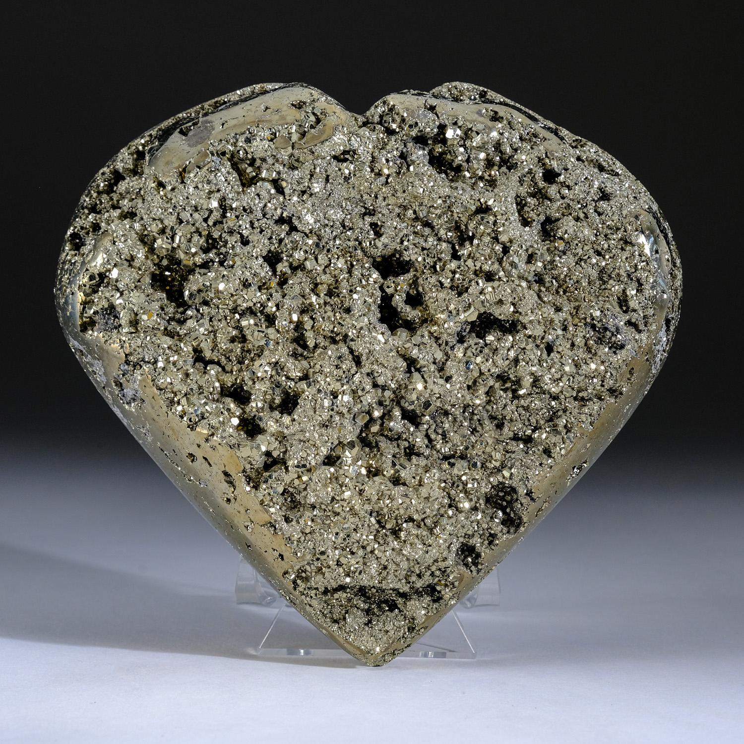 AAA-quality polished Pyrite heart from Peru. This mineral's metallic luster and pale brass-yellow hue gives it a superficial resemblance to gold. This piece is polished to a high mirror finish with mesmerizing crystal pockets revealing its natural
