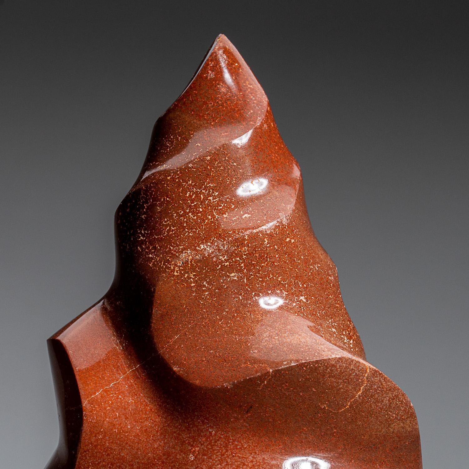 This top quality, hand polished Red Jasper flame freeform from Madagascar features a deep red coloring ranging from bright to brownish-red. Red Jasper is renowned for its ability to relieve anxiety, regulate emotional frustrations, and impart