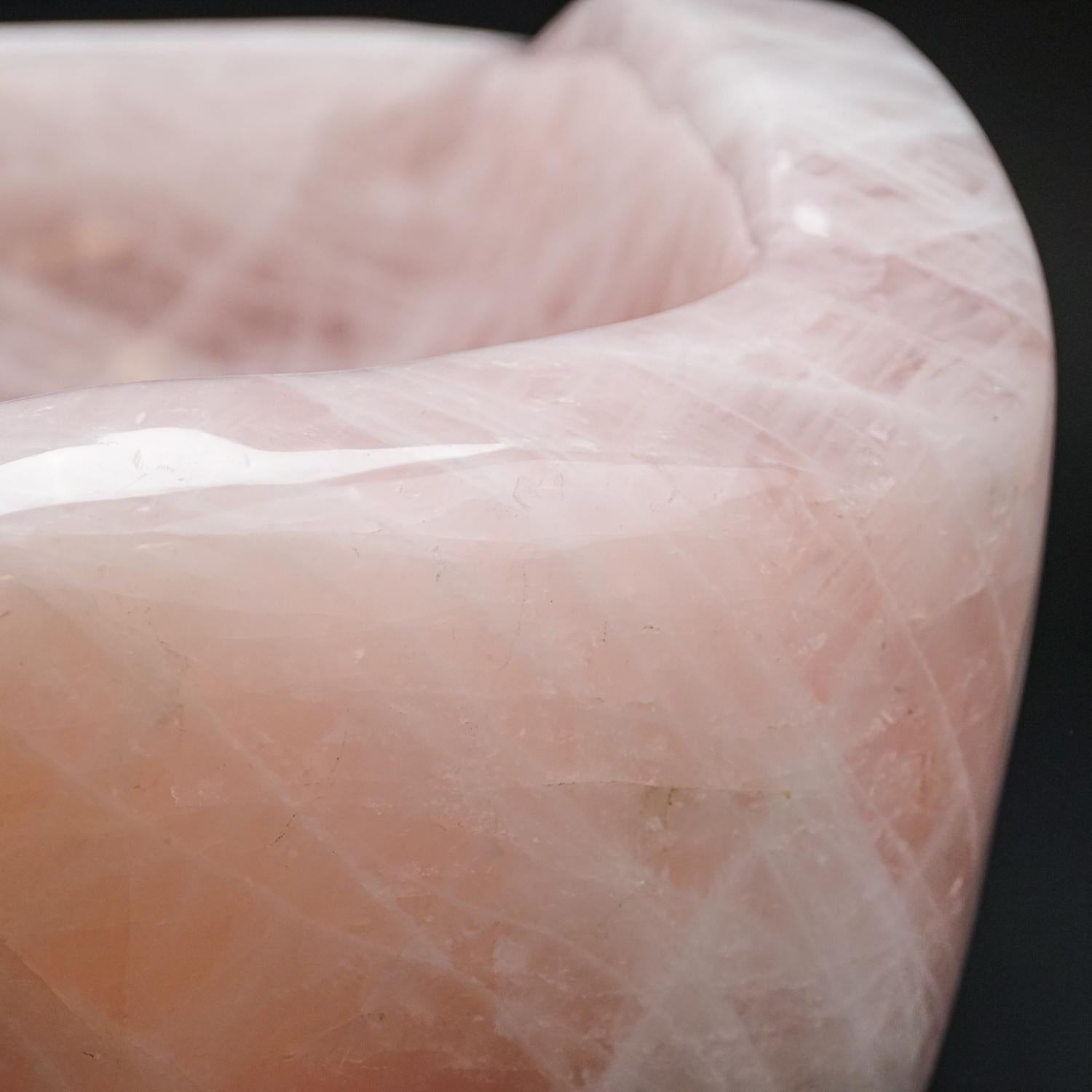 Museum quality, carved from a single piece of solid, gem quality, Brazilian Rose Quartz. This Rose Quartz bowl has beautiful transparancy with a warm pink color and is polished to a mirrored finish. Truly unique, this piece would make an incredible