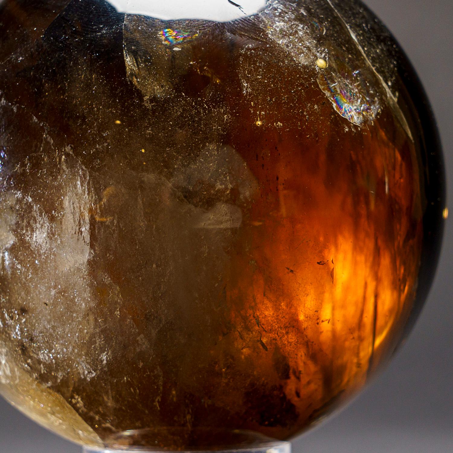This expertly polished Smoky Quartz sphere from Brazil is a museum quality and boasts high levels of transparency and reflectivity, making it a valuable addition to any crystal, mineral, or collectible collection. It has a subtle yet powerful energy