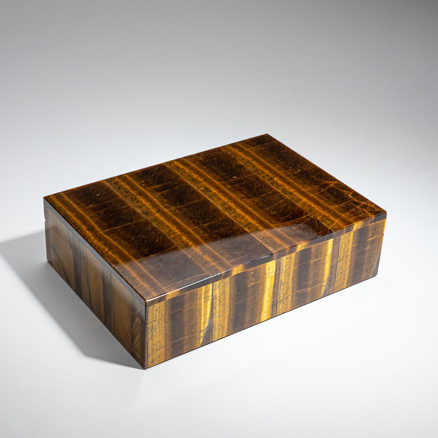 Large rectangle jewelry box handmade from the finest top grade natural Tiger's eye from Africa, with rich golden color and stunning chatoyancy banding. The box has been hand polished to a mirror finish. The lid has a piano hinge opening to reveal a