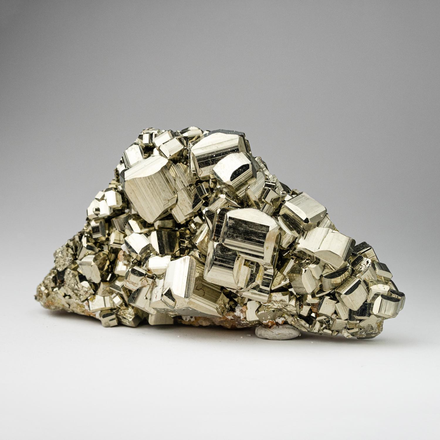 A world-class cluster of perfectly terminated cubic Pyrite crystals, interlocked on it's natural Basalt matrix. This specimen was discovered in the famous mines of Huanuco Province, Peru - considered one of the finest locations in the world for