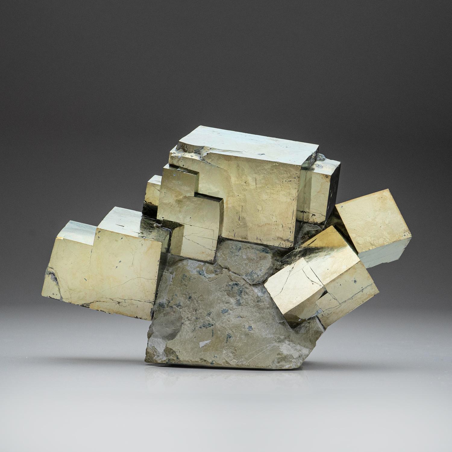 A world-class cluster of perfectly terminated cubic Pyrite crystals, interlocked on it's natural Basalt matrix. This specimen was discovered in the famous mines of Navajun, Spain - considered one of the finest locations in the world for Pyrite. This