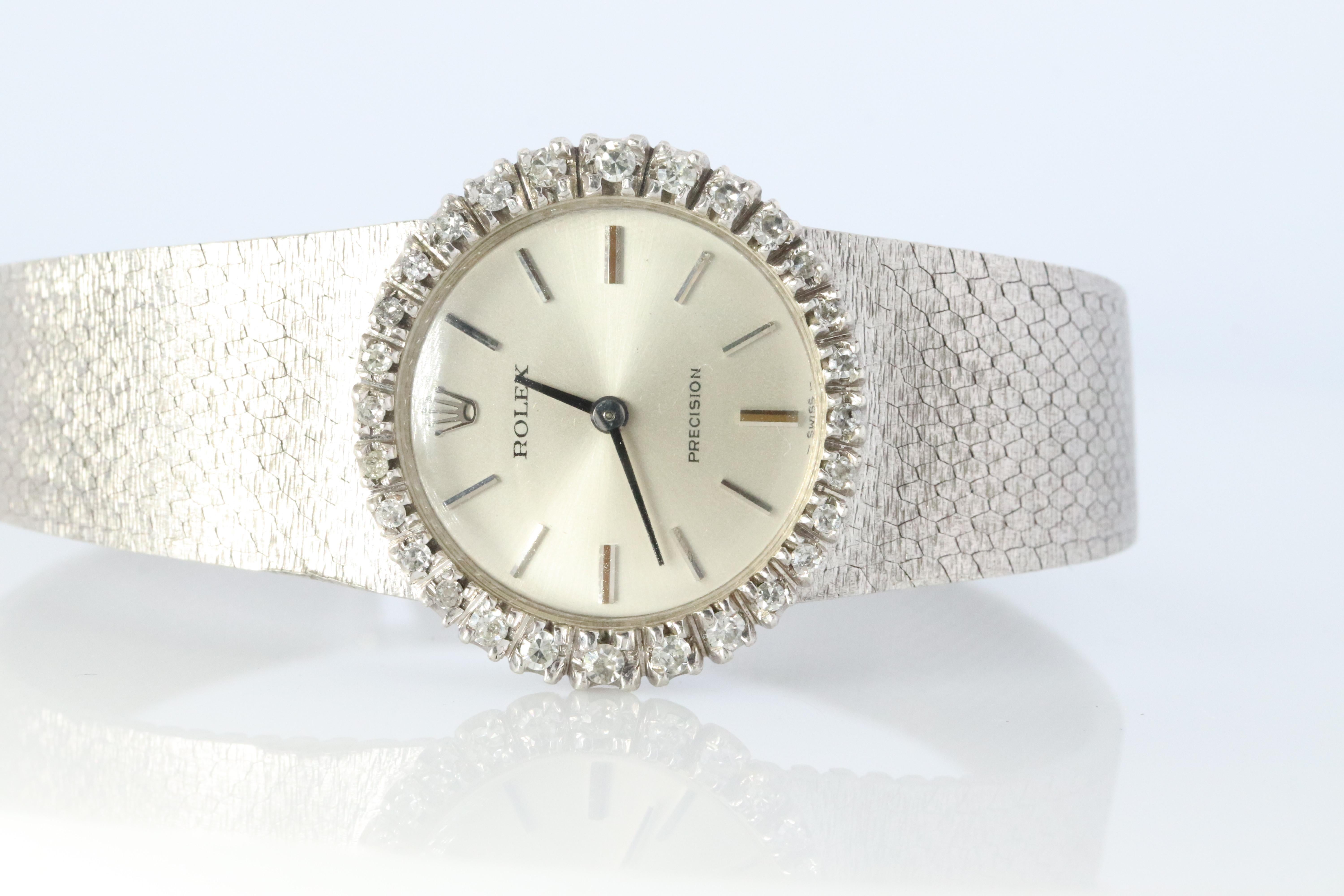 Stainless Steel Rolex Precision Ladies mechanical Movement Wristwatch. Circa 1970s. 

1400 Caliber Rolex Movement Ref. 2649.

Beautiful Watch. Manual Windup mechanism. 

Case and Bracelet is Stainless Steel with diamond bezel.

6.75inch wrist