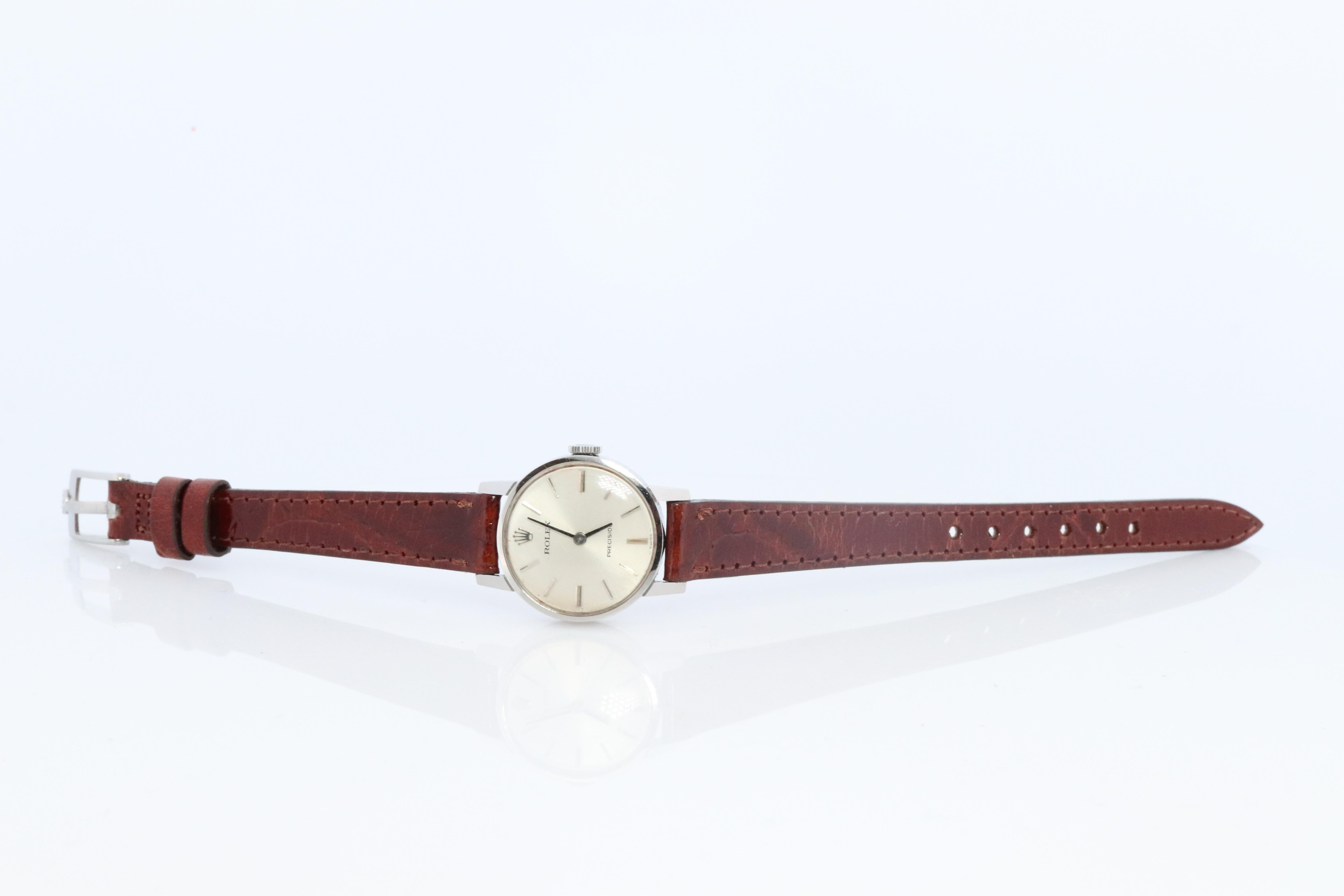 Stainless Steel Rolex Precision Ladies mechanical Movement Wristwatch. Circa 1970s. 

1400 Caliber Rolex Movement Ref. 2649.

Beautiful Watch. Manual Windup mechanism. 

Leather Band New with genuine Rolex Buckle.
21mm round case

Condition: Watch