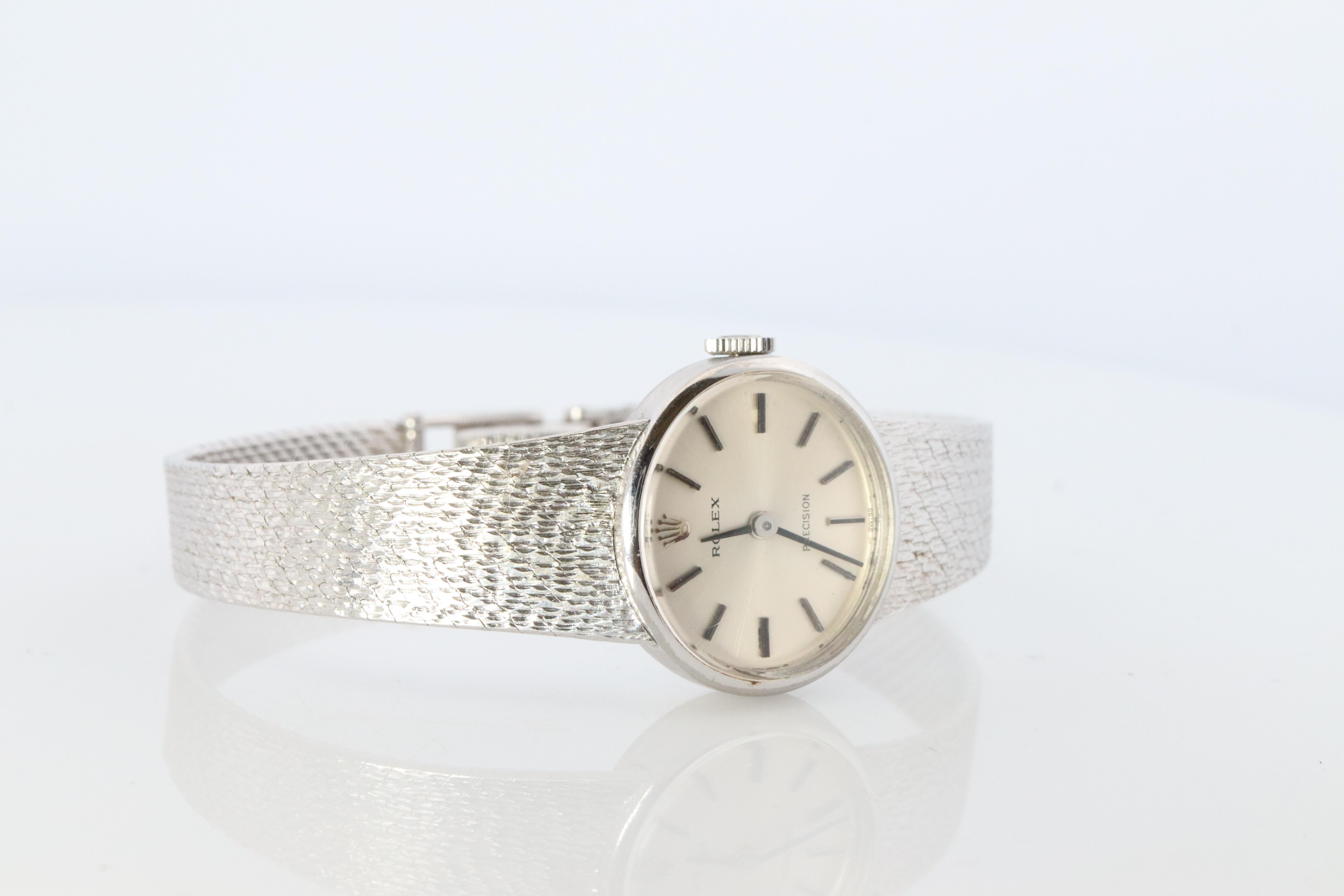 Stainless Steel Rolex Precision Ladies mechanical Movement Wristwatch. Circa 1960s. 

1400 Caliber Rolex Movement Ref. 2653.

Beautiful Watch. Manual Windup mechanism. 

Case is Stainless Steel
Bracelet is Stainless Steel.

18mm by 20mm oval