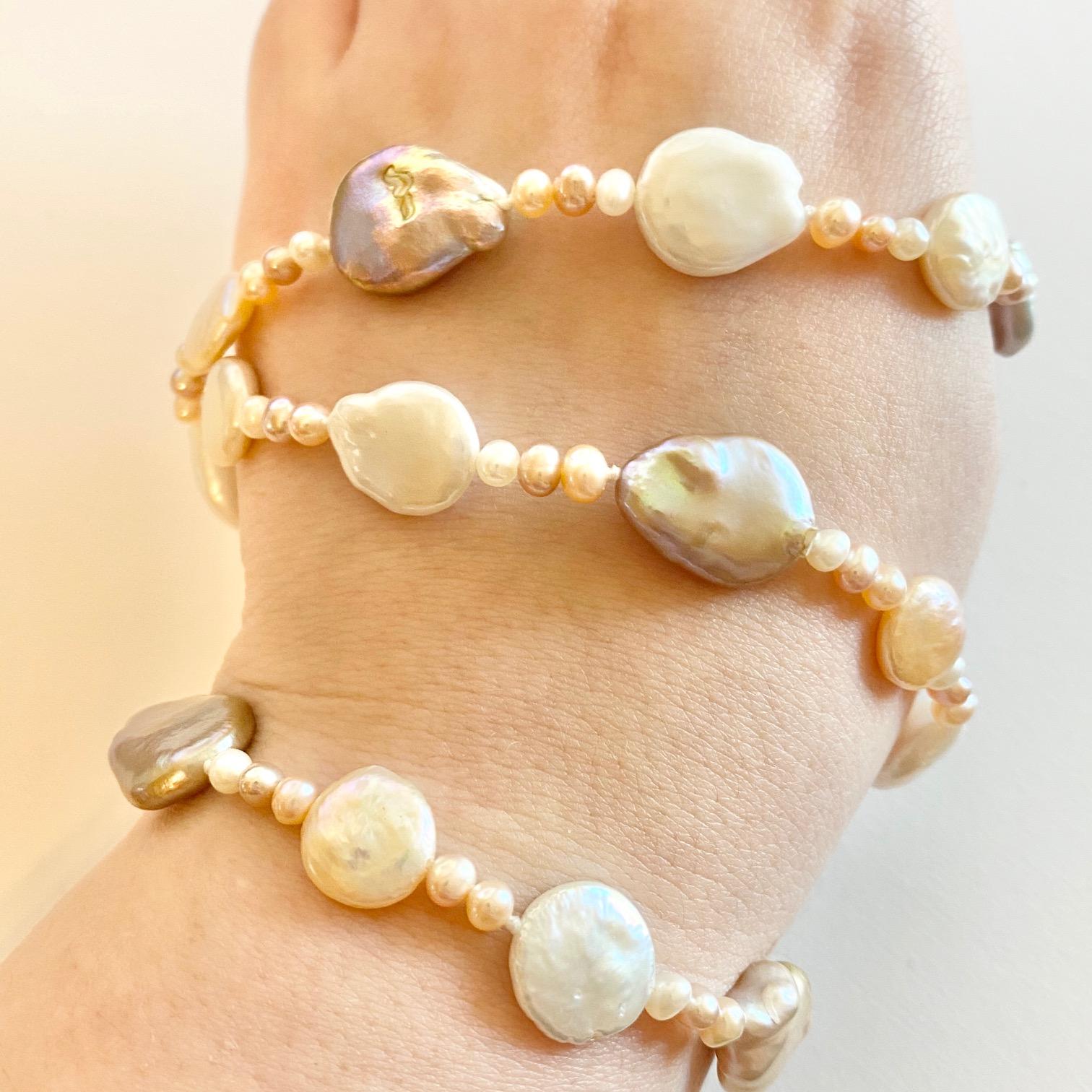 This pearl necklace has tons of gorgeous, creamy colors throughout it. These pearls have organic shapes that give them a unique style! The colors are a mix of rose pinks and whites that goes perfectly with any skin tone! The pearls range in size and