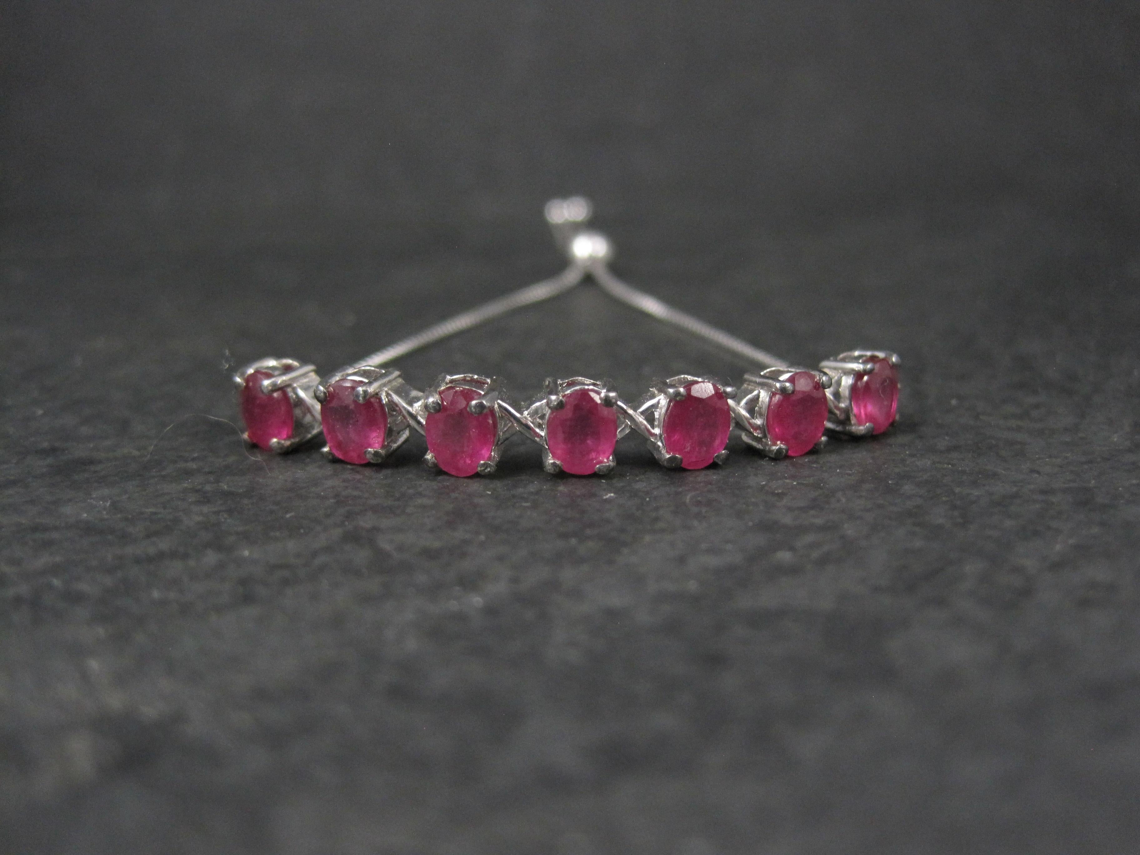 This gorgeous bolo bracelet is sterling silver.
It was made for Kay by Chuck Clemency.

It features 7 oval cut, 4x5mm ruby gemstones.
The bracelet is adjustable from 5 to 9 inches.

Marks: 925, STS

Condition: Excellent