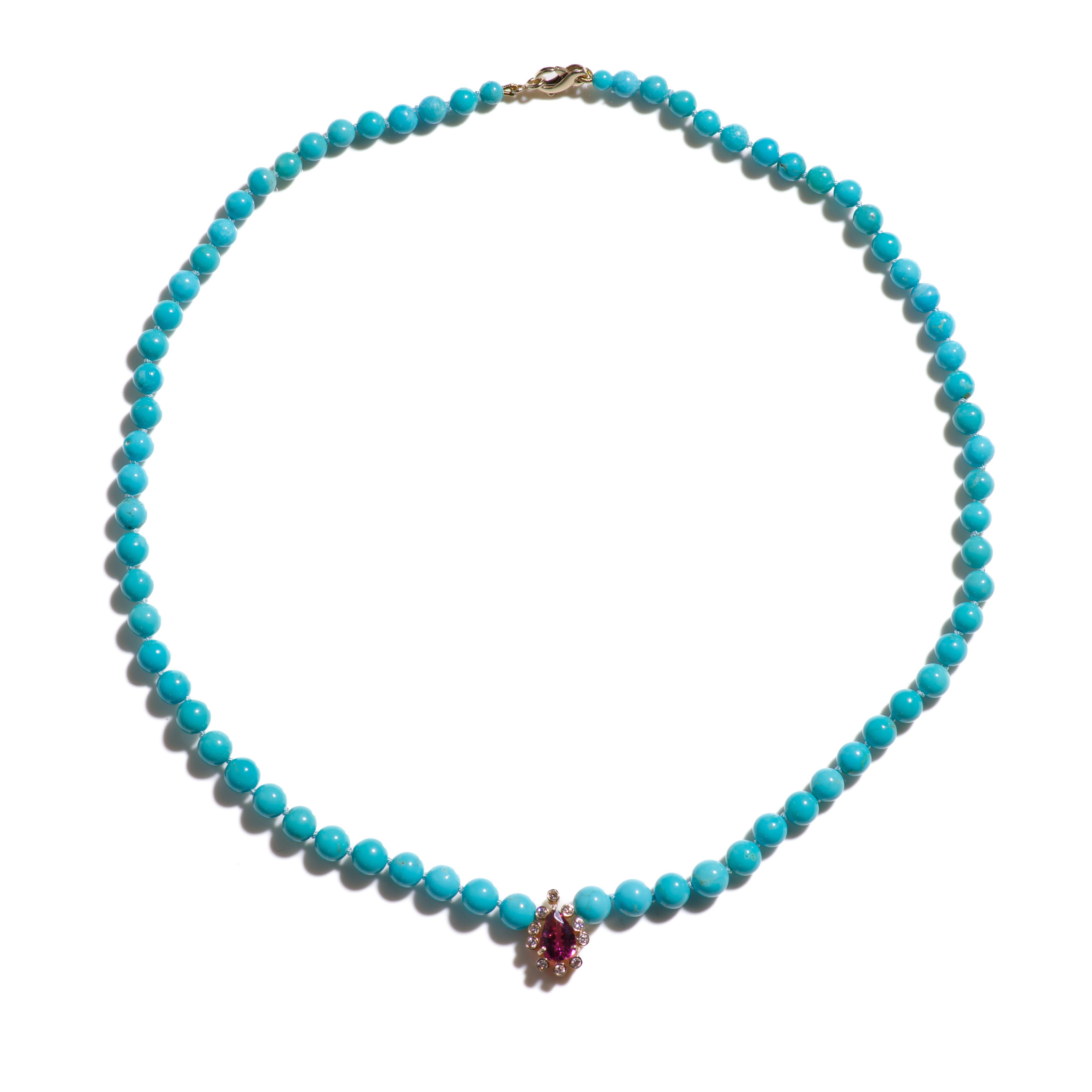 A regal handmade statement necklace with extremely rare and pure Sleeping Beauty Turquoises accompanied by a large deep pink tourmaline set in 14k gold surrounded by sparkling rose cut diamonds.  

This statement piece features genuine turquoises
