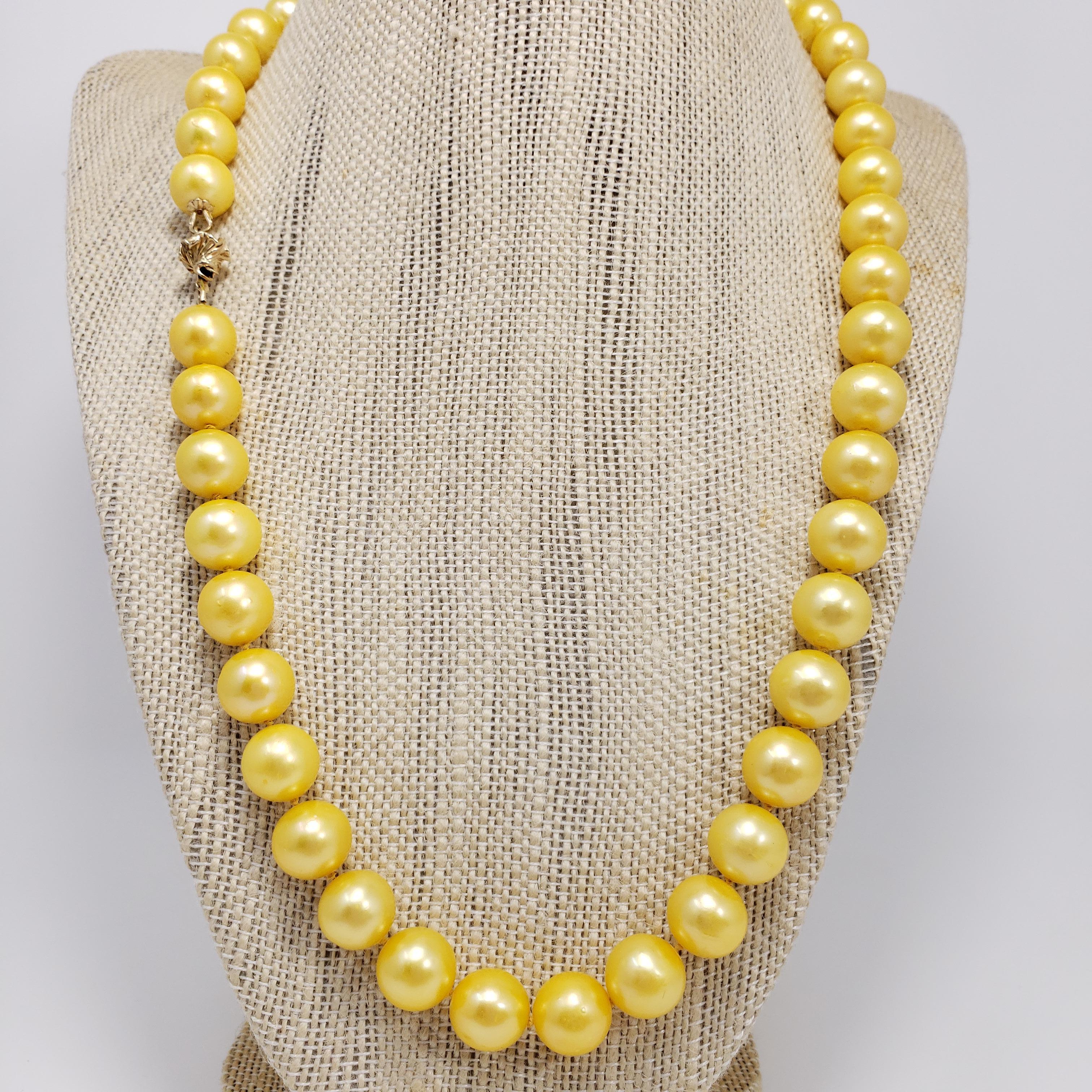 An exquisite necklace that features 10.5mm glowing golden South Sea pearls on a hand knotted silk string. Fastened with 14K yellow gold garlic clasp. A luxurious accessory perfect for any style!

Hallmarks: 585