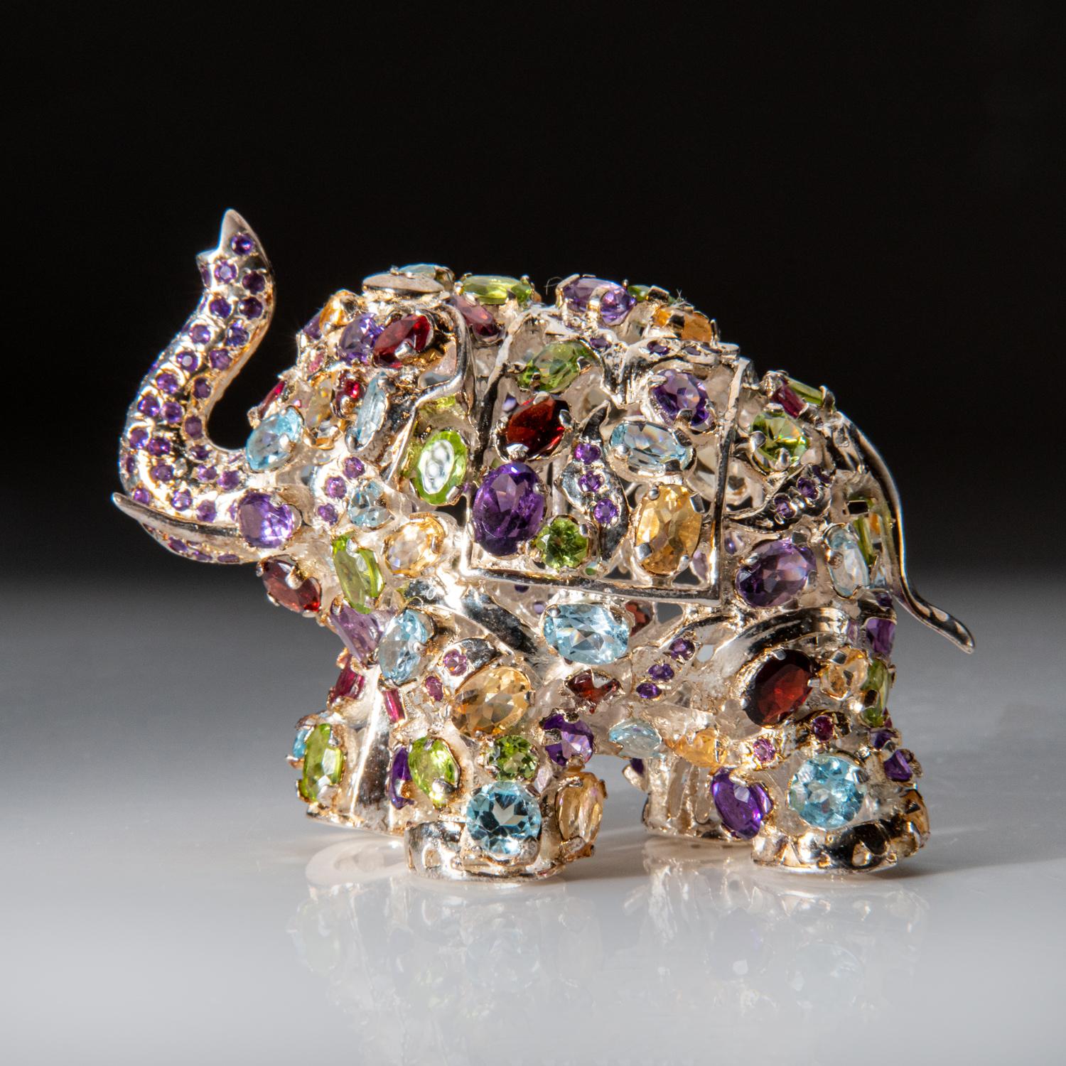 This unique Sterling Silver Elephant carving is handcrafted in India. Made with genuine sterling silver, it is sprinkled with precious gemstones including red garnet, paridot, amethyst, citrine, and blue topaz for a luxurious touch. A perfect and