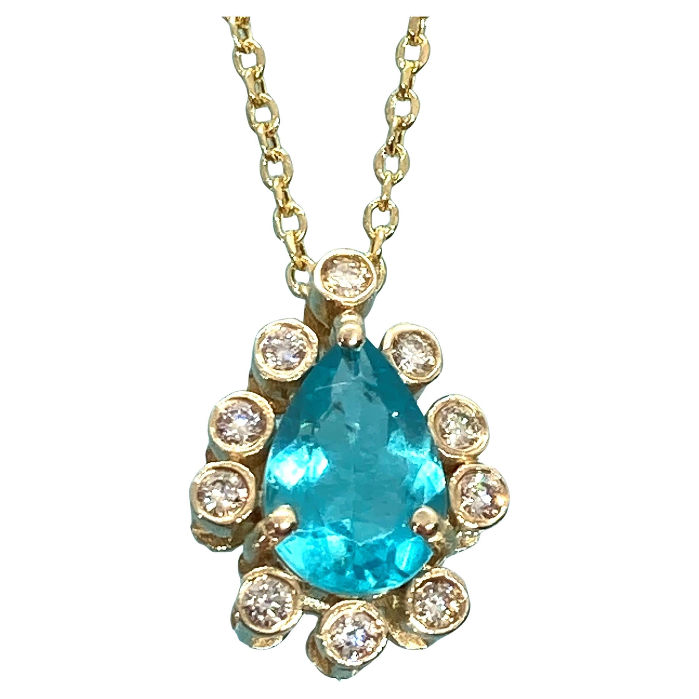 A true eye-catching azure blue sparkling pendant; this Paraiba Apatite from Madagascar is surrounded by ten (10) sparkling rose cut diamonds that catch the light in dazzling ways, is a minimalistic and timeless jewelry piece that can be combined