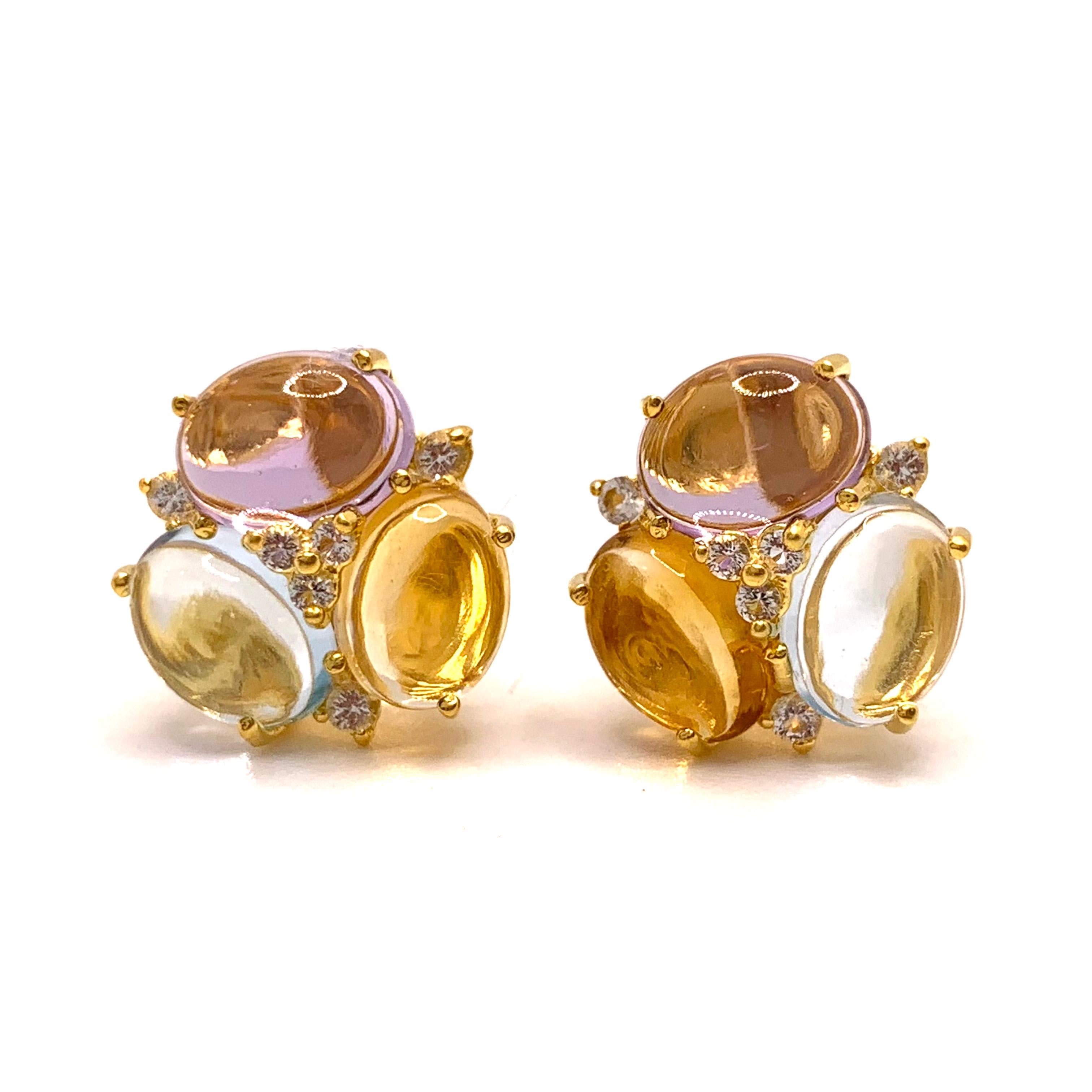 These stunning pair of stud earrings feature sets of oval cabochon-cut amethyst, citrine, and sky blue topaz adorned with white topaz rounds, handset in 18k yellow gold vermeil over sterling silver. The oval stones are very clear (zero inclusion!),