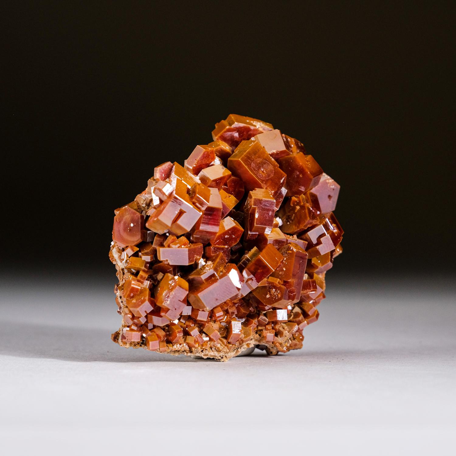 From Mibladen, Atlas Mountains, Khénifra Province, Morocco An exceptional world-class cluster of hexagonal brick-red Vanadinite crystals with glassy luster on limonite matrix. These large well-defined and undamaged crystals, are fully terminated