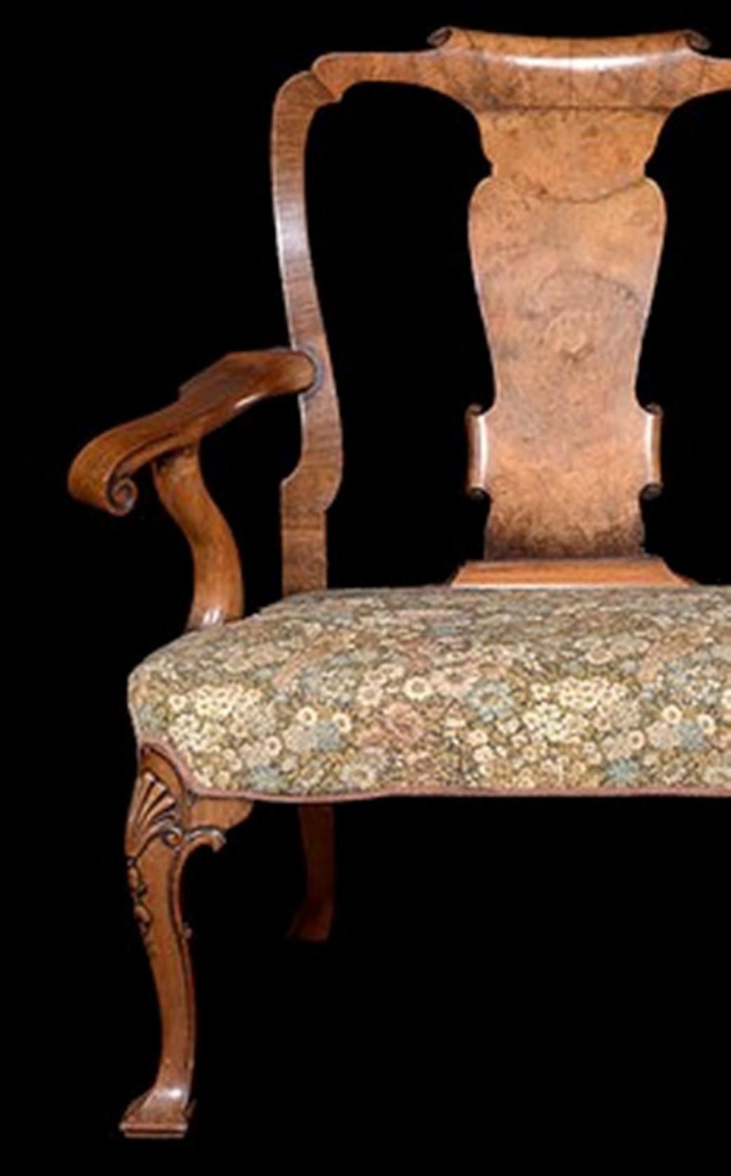 A Geo 11 style carved walnut chair-back sofa with vase shaped splats and scroll end arms.

The whole supported on six cabriole legs with shell carving to the knees and ending on chiseled pad feet.
The seat is currently upholstered in a floral