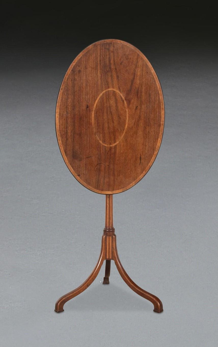 ﻿ A rare C18th Chinese export occasional table, of elegant design and constructed of exotic hardwoods including Padouk. The oval tilt top with blonde wood crossbanded edge and repeating inlay to the centre. The slender column also with inlaid strips
