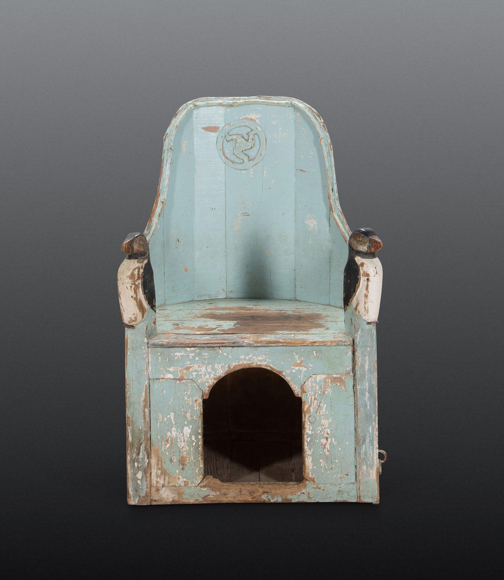 A rare late 18th/early 19th Century country armchair, of unusual naive form from the Isle of Man. The swept back with naturalistic carved wood moulded edge and carved IOM emblem of the three legs to the middle of the back, with charming carved