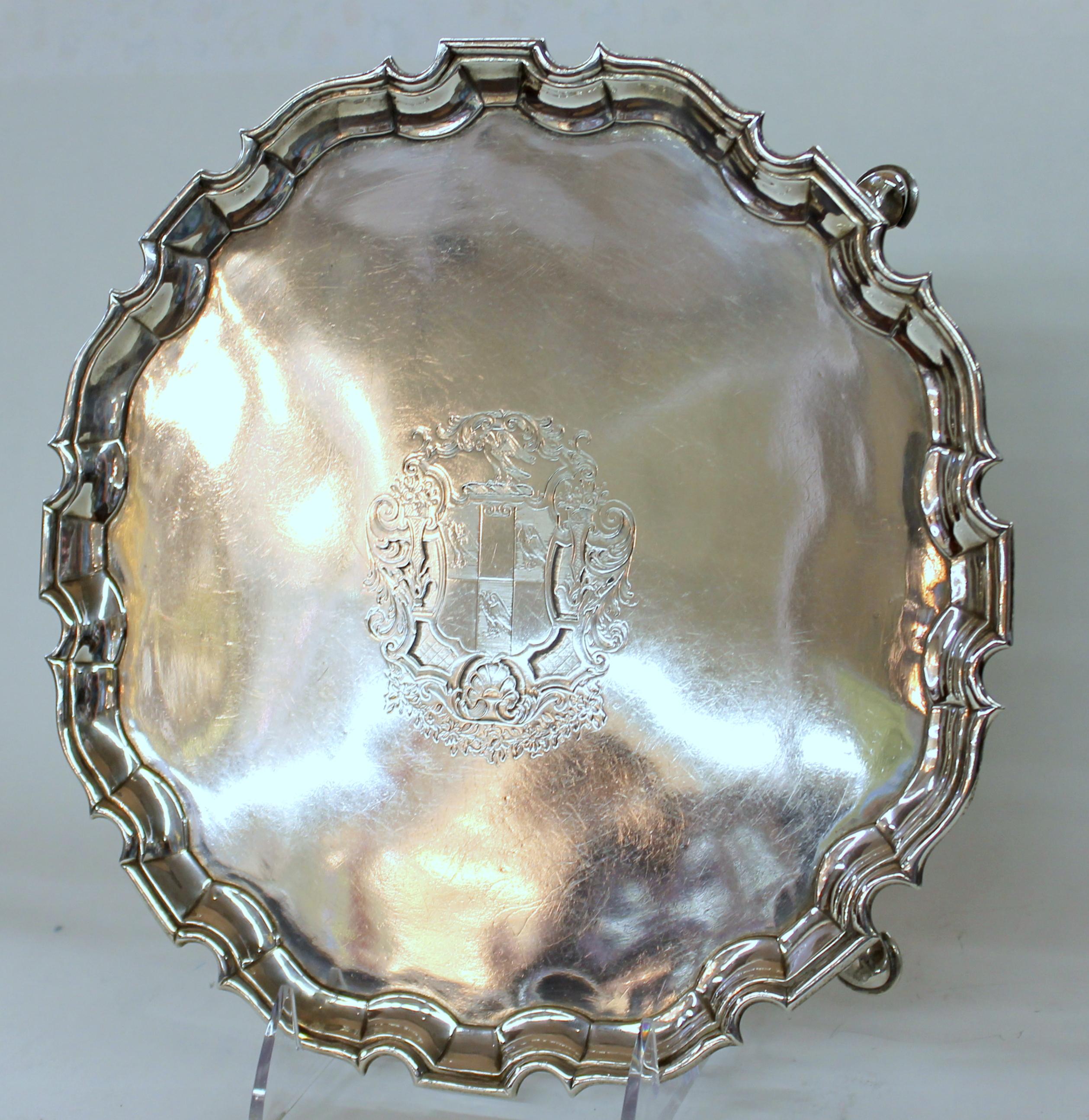 Exquisite heavyweight hallmarked sterling George III Chippendale style salver with exceptional Hand-engraved armorial crest; piecrust edge; fabulous ball and claw feet.
Hallmarks for London, 1798-1799, and Maker's Marks for George