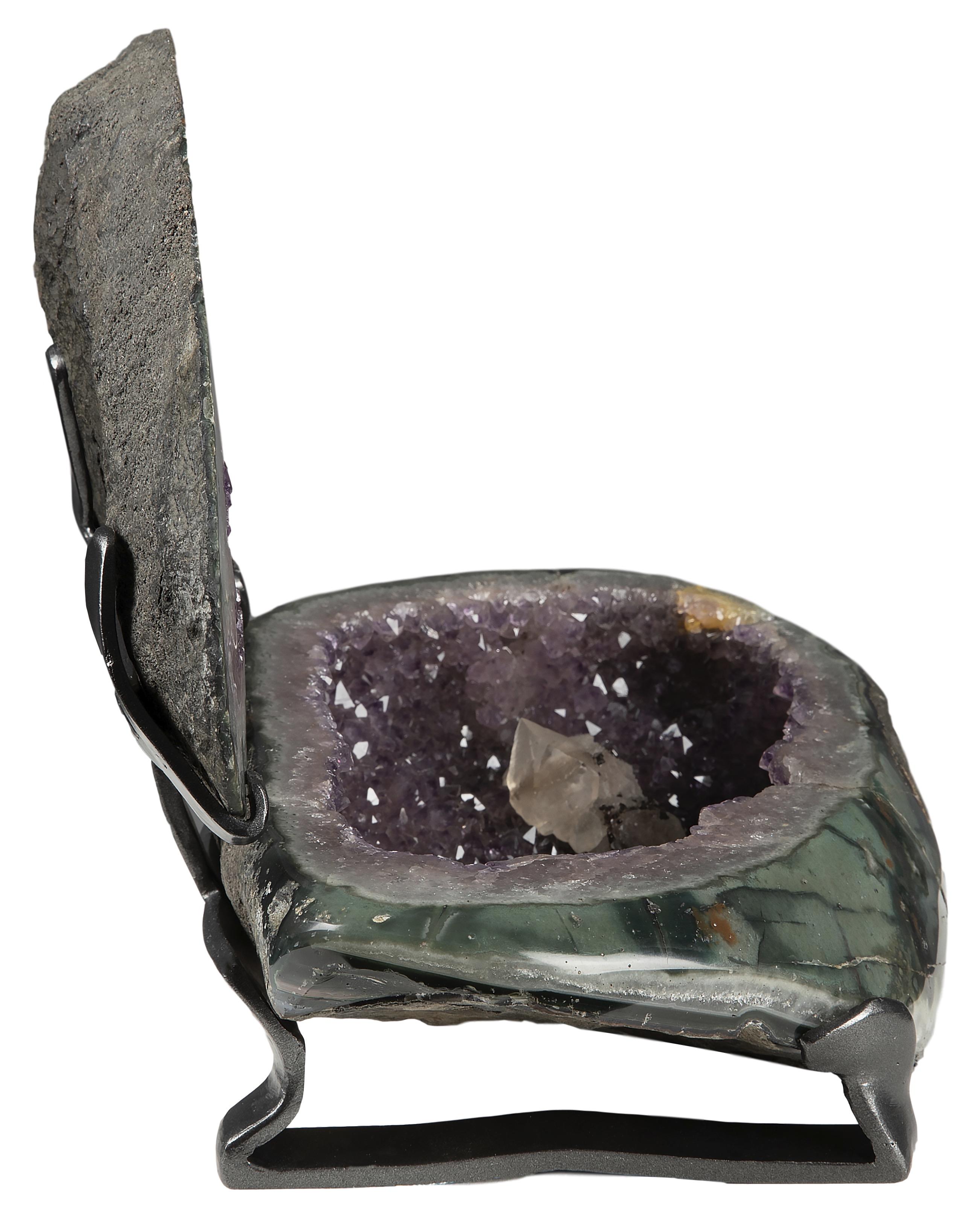 This piece celebrates the visual phenomenon of the geode in its entirety, with some parts of the sculpture being rough basalt, and others showcasing combinations of the amethyst, variation of quartz and calcite formations. From its back of rough