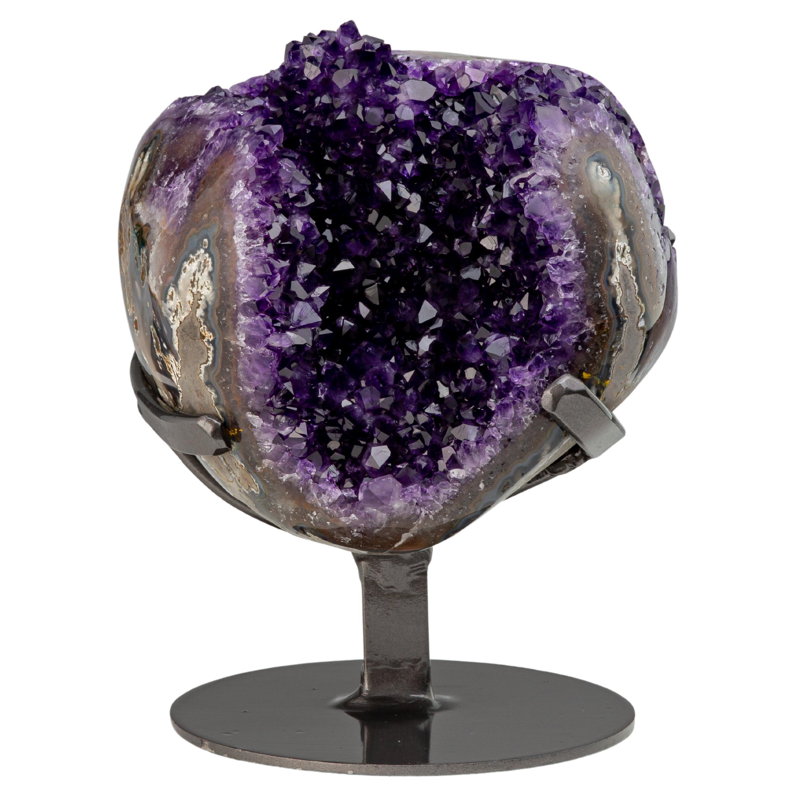 Geode with deep purple amethyst crystals, a central stalactite and agate borders