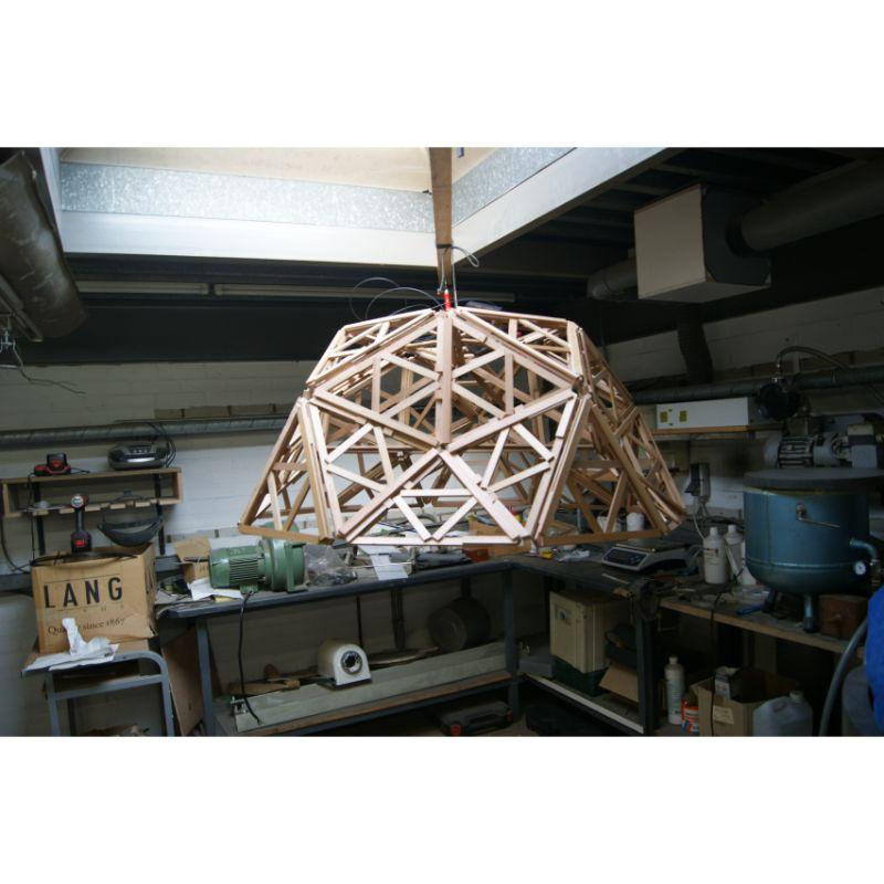 Geodesic pendant light, half globe by Paul Heijnen (2013)
Dimensions: H 70 x L 140 x W 140 cm
Materials: red cedar

Available in Complete globe.

This complex hanging lamp design is inspired by the geodesic domes of Buckminster Fuller. The