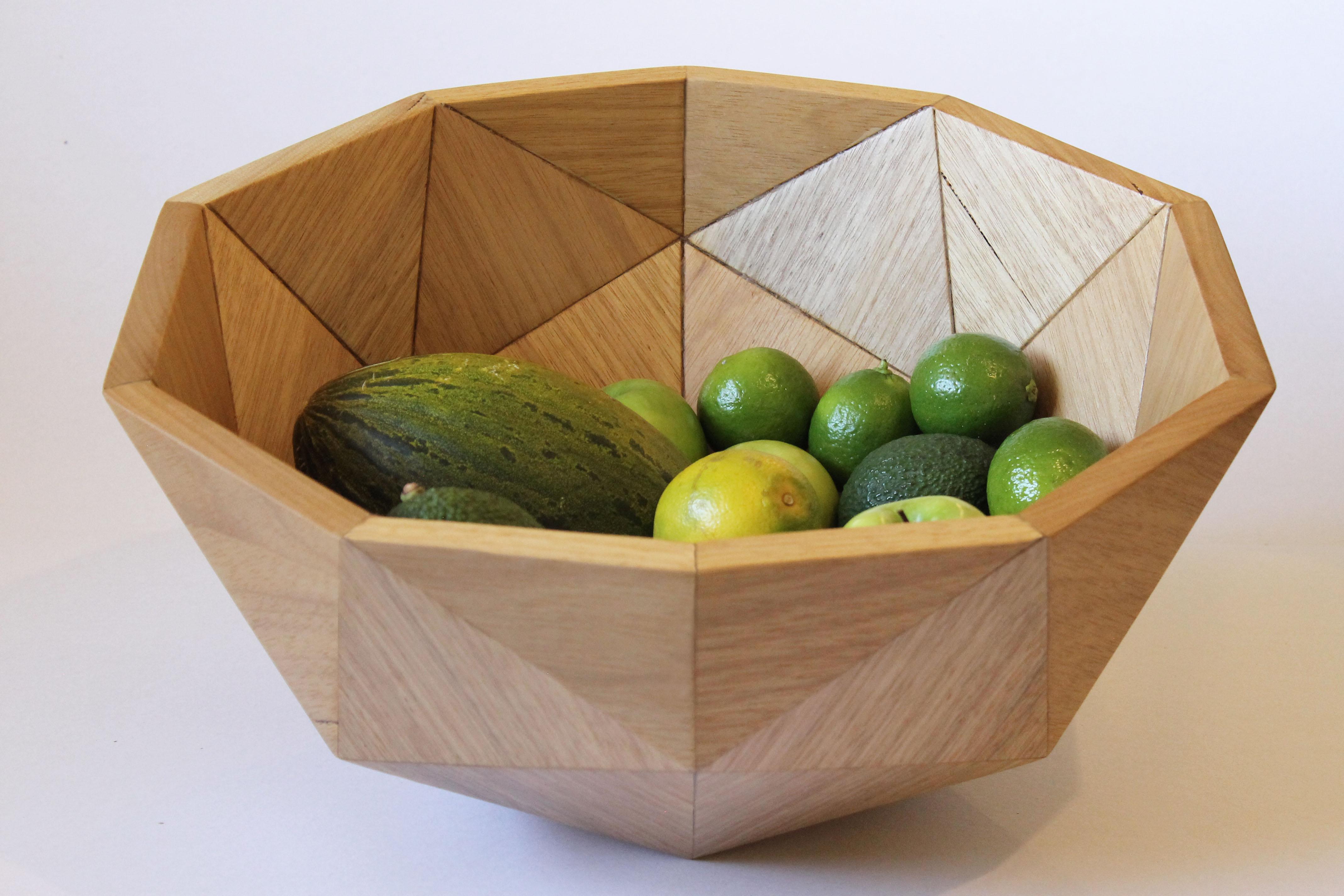 Inspired by geometry, it is composed of 32 triangular pieces that together form a geodesic. 
Entirely assembled by hand and made of certified Brazilian wood, it has non-toxic finish and can serve as either decorative element or fruit bowl. 