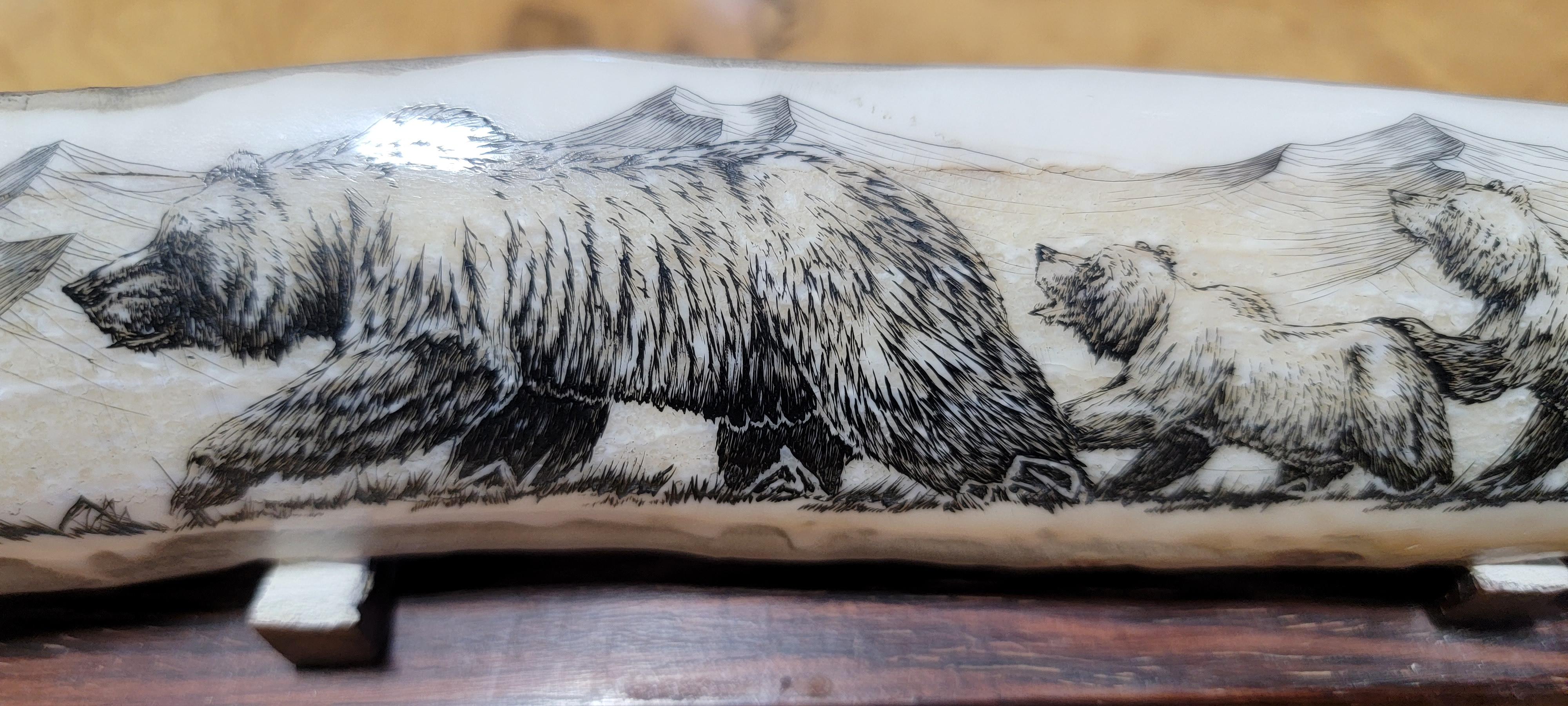 Geoff Olsen fine scrimshaw carving on fossilized walrus bone. Depicting a mother grizzly bear and her three cubs with Alaskan mountain range in background. Signed and dated 