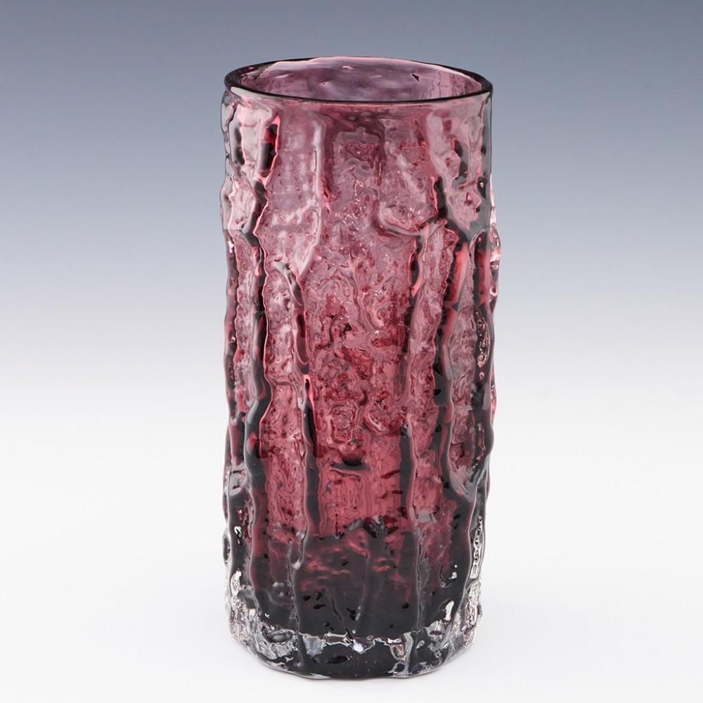 Heading : Whitefriars bark vase
Date : 1966-1980
Origin : Wealdstone, England
Bowl Features : Textured 'bark' glass in the aubergine colourway cased in clear
Type : Lead
Size : 23.5cm height, 10.2cm diameter
Condition :Excellent, no chips or