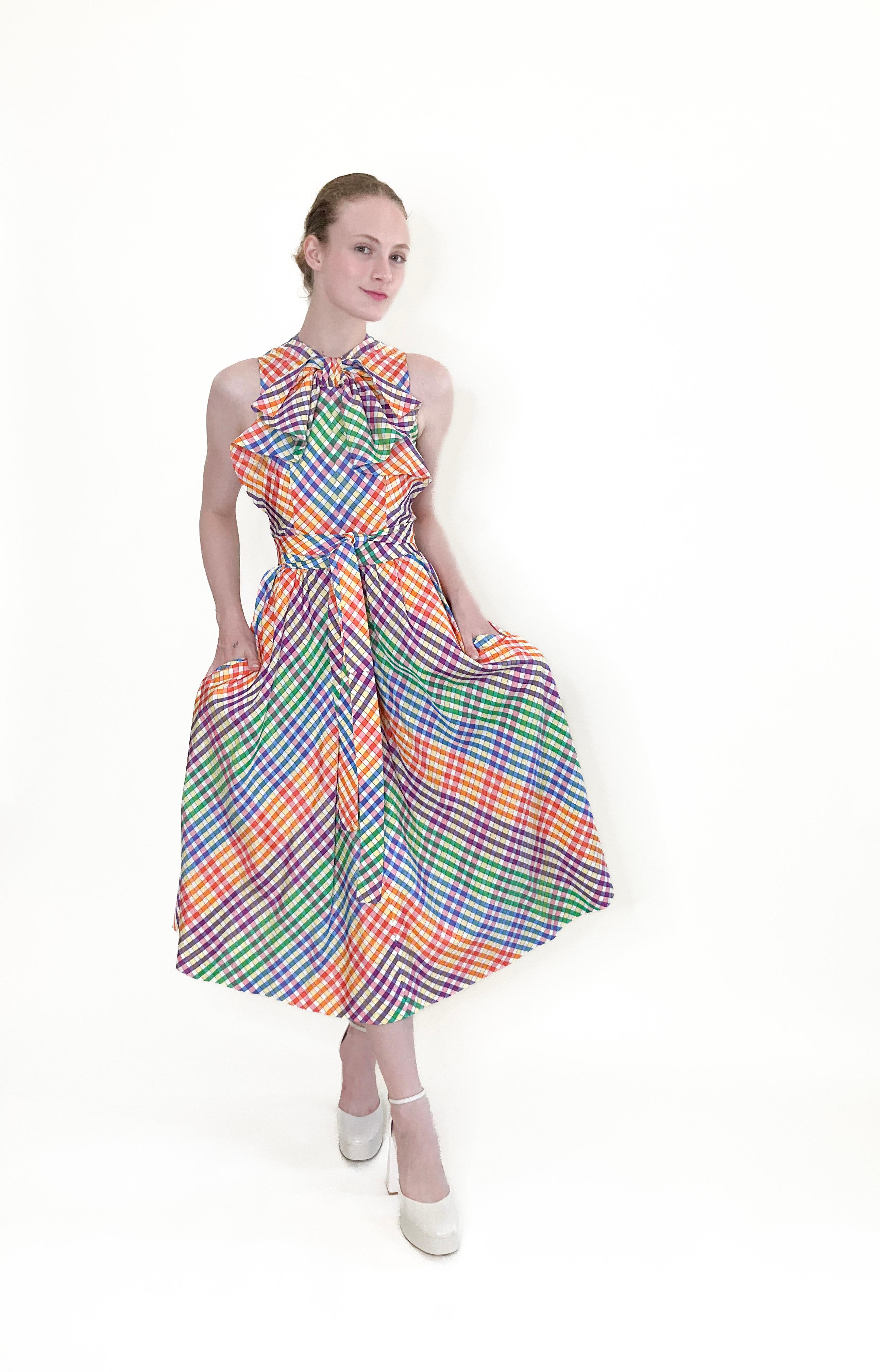 Experience the timeless elegance of 70s style with the Geoffrey Beene Rainbow Plaid Dress. With its playful rainbow colors and convenient pockets, this dress is both fashionable and functional. Perfect for any occasion, it's a must-have for any