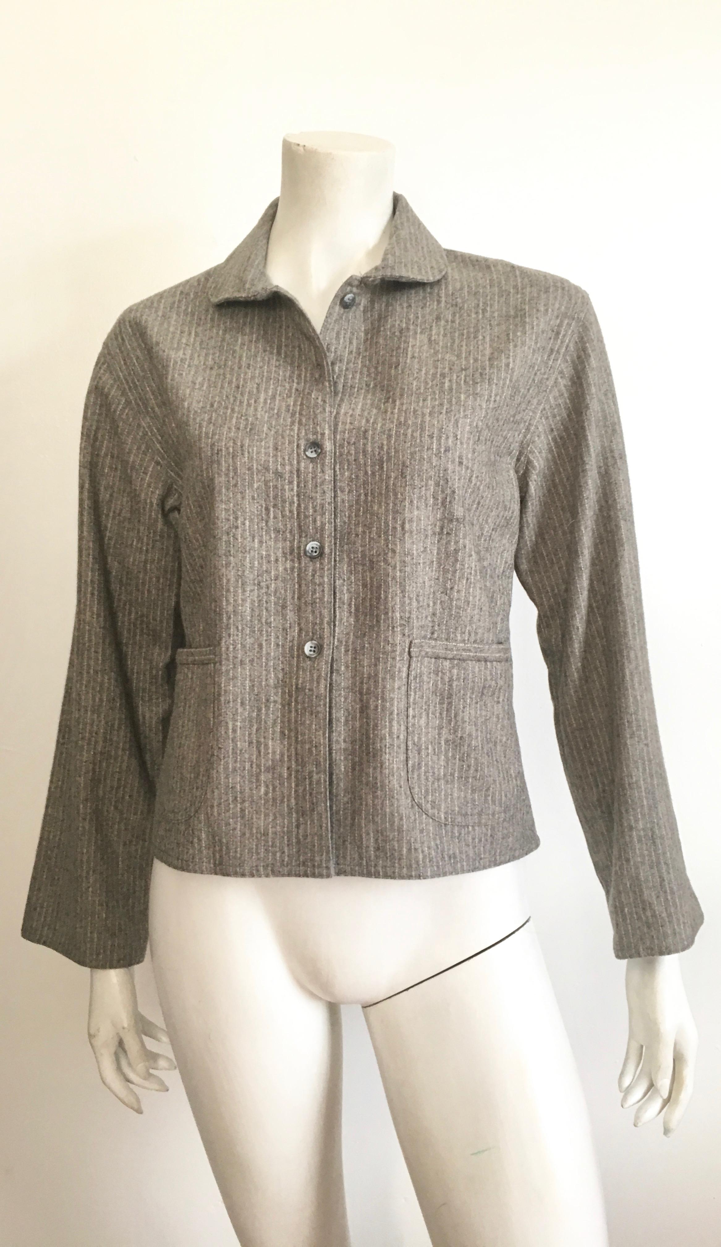 Geoffrey Beene 'BeeneBag' 1980s grey pinstripe wool jacket is labeled a size 8 but will also fit a size 6 nicely. This classic timeless jacket is not lined and has two front pockets in front.  Wear this light weight jacket with your 1980s Calvin