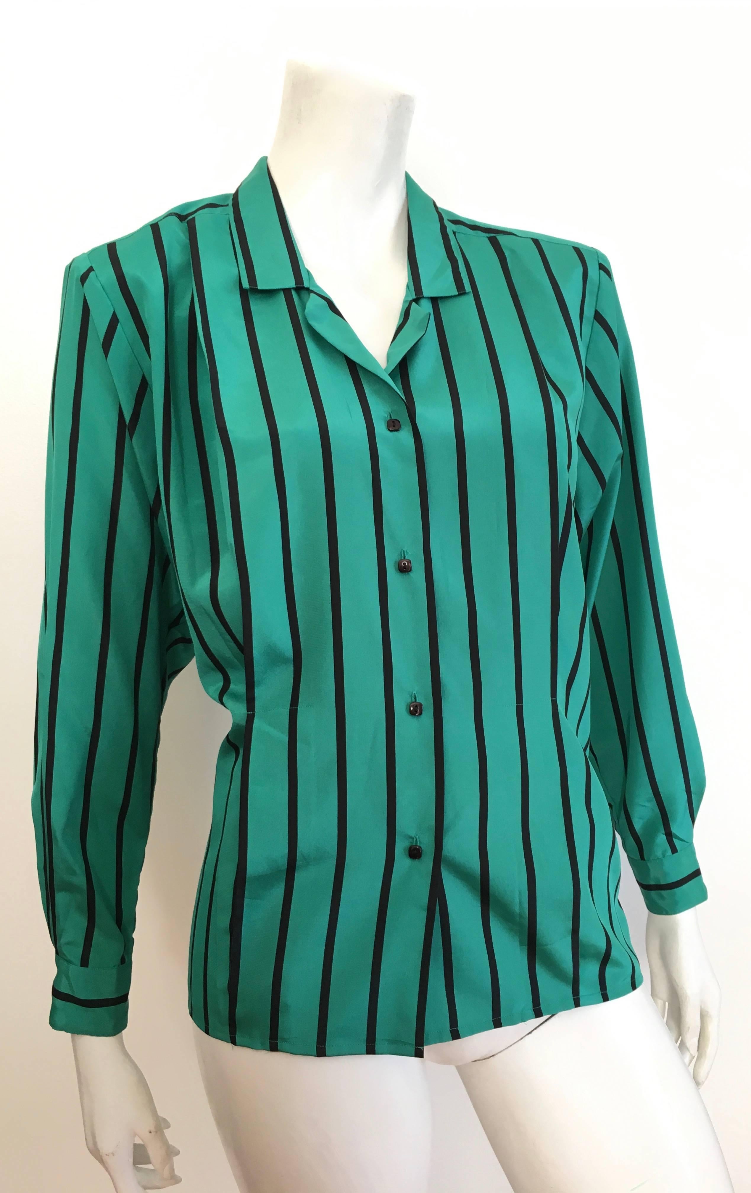 Geoffrey Beene 1980s green & black striped long sleeve blouse is a size 6. Blouse has very mild shoulder pads that can be removed if desired. There are two inverted pleats on each side of front of blouse. Wear this 1980s Geoffrey Beene blouse with