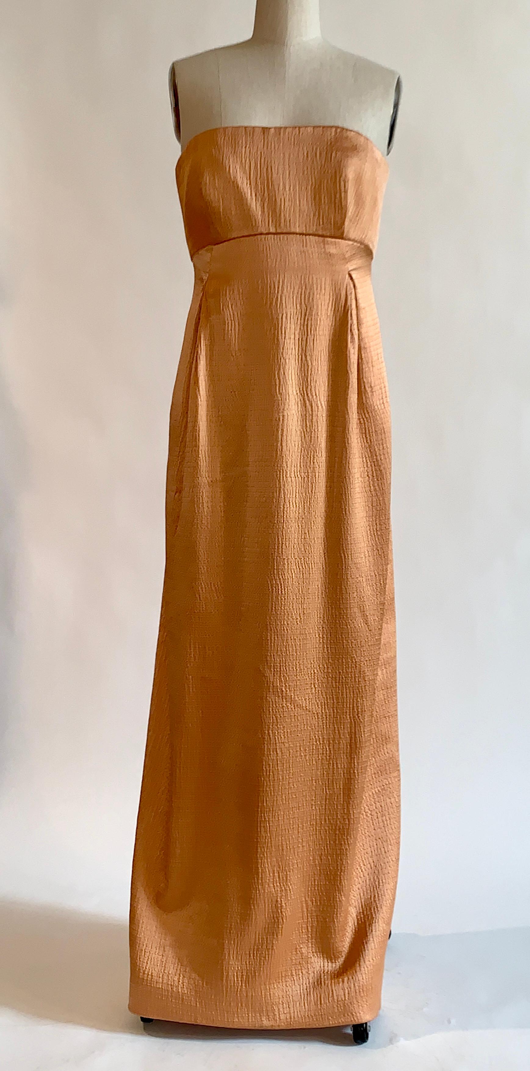 Geoffrey Beene textured silk strapless empire waist long evening dress. Amazing warm apricot color, and beautiful texturing of the silk. Back center slit. Built in boned structuring at top bodice with interior zip, closes with a center back zip and