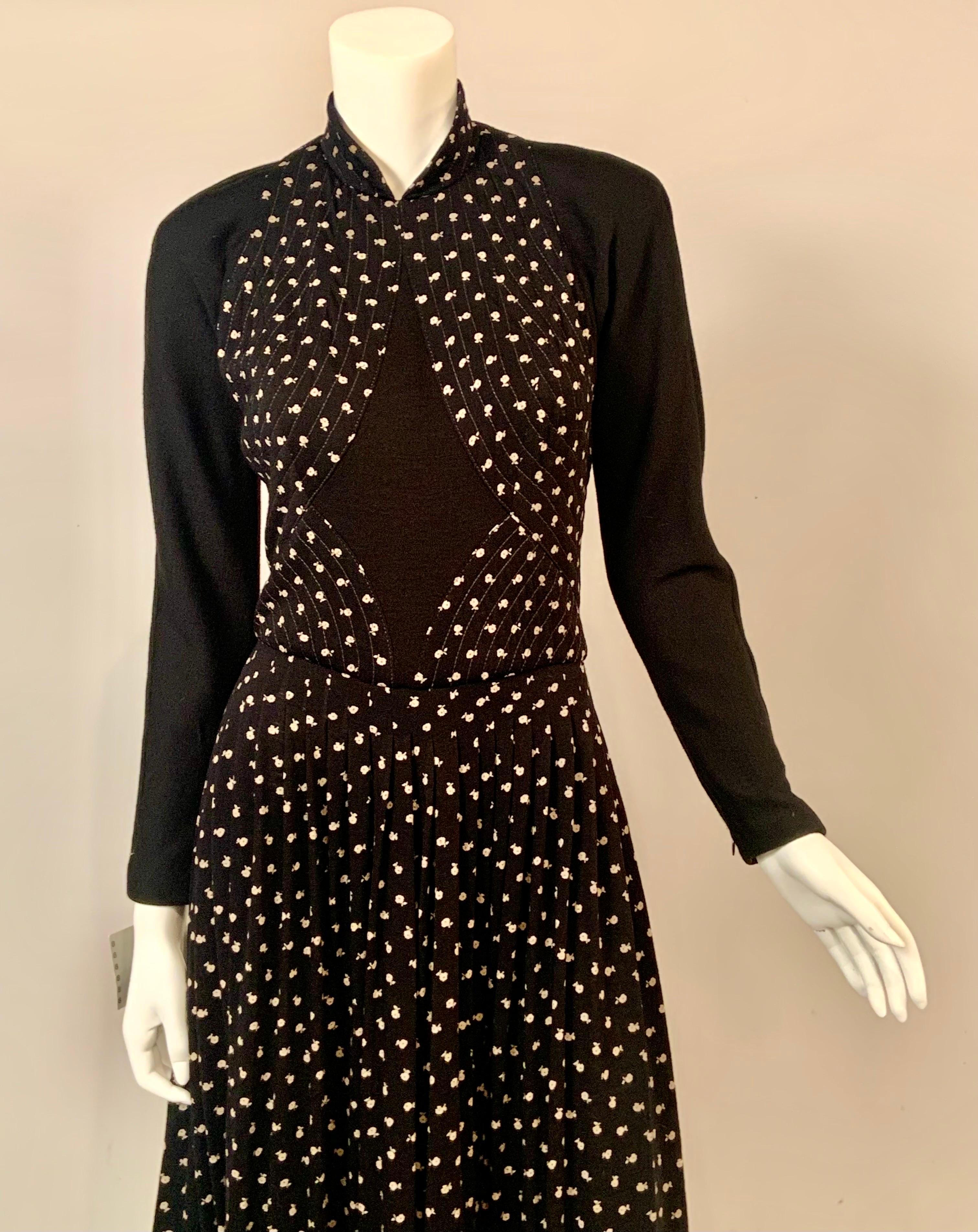 This fabulous Geoffrey Beene evening gown is made from a black and white wool floral print with quilted sections, and black wool jersey at the center of the bodice, the back and the long sleeves.  The skirt is gently pleated below the wide quilted