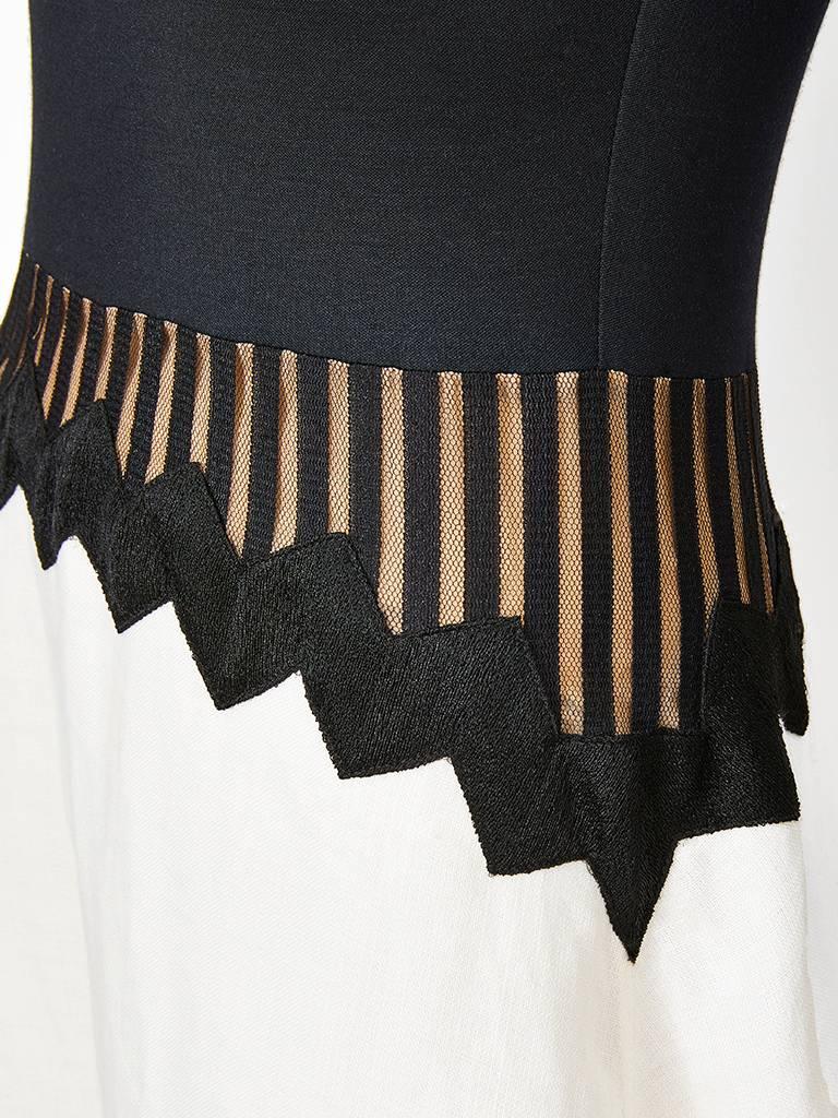 Geoffrey Beene, black and white evening dress, having a black. silk jersey, raglan sleeve bodice, ending at the waist. There is a black, gross grain, zig zag detail below the waist that goes around the abdomen, hip and across the back. Below the