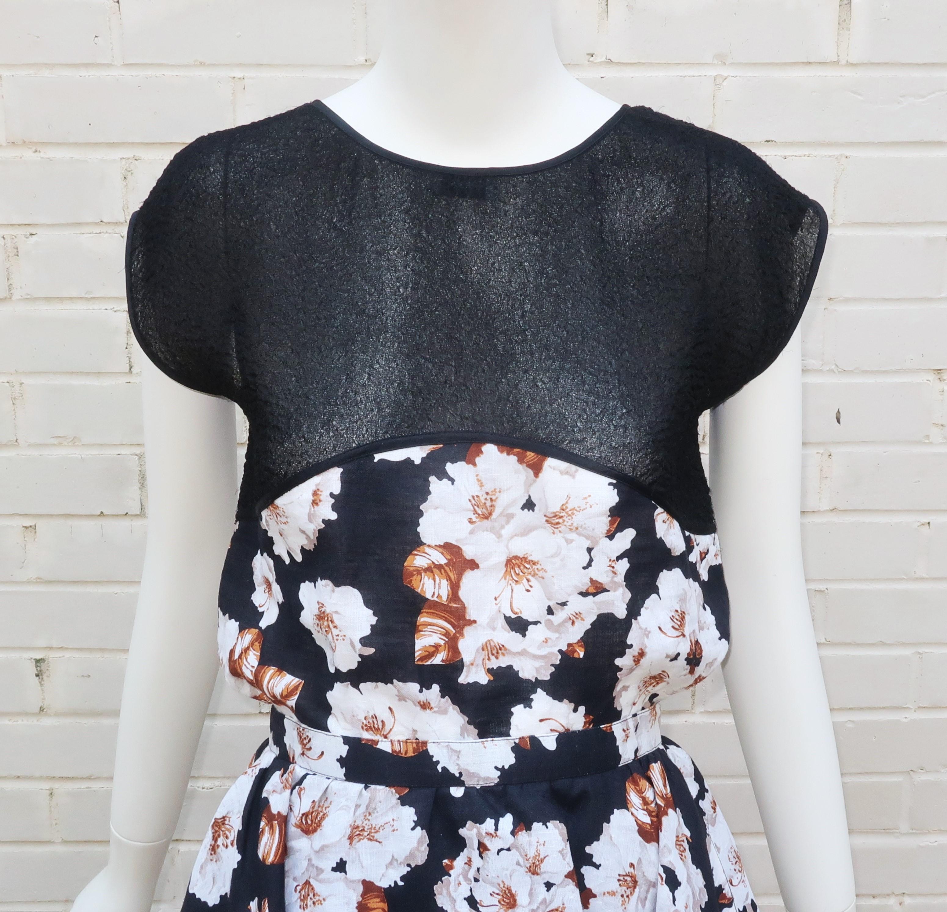 This 1970's Geoffrey Beene two piece dress ensemble is a vision of loveliness.  Both pieces are are a combination of a unique puckered black sheer fabric and a floral linen depicting white flowers with brown accents.  The pullover boxy top scoops