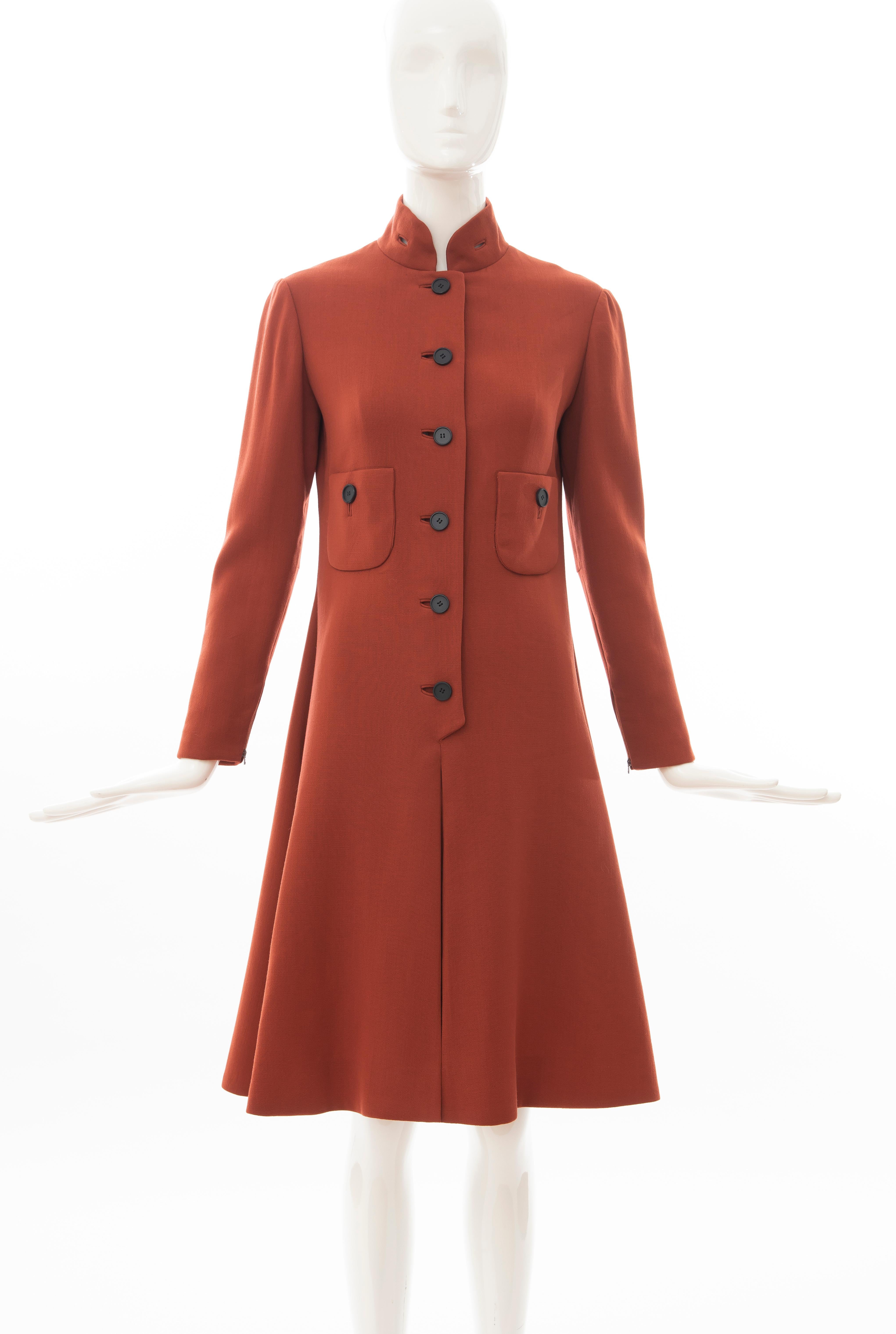 Geoffrey Beene, Circa 1960's cinnamon wool crepe princess style button front dress, nehru collar, two front pockets, long fitted sleeves with zipper closure and box pleated skirt.

No Size Label:
Bust: 32, Waist: 29, Hip: 35, Shoulder: 15, Sleeve: