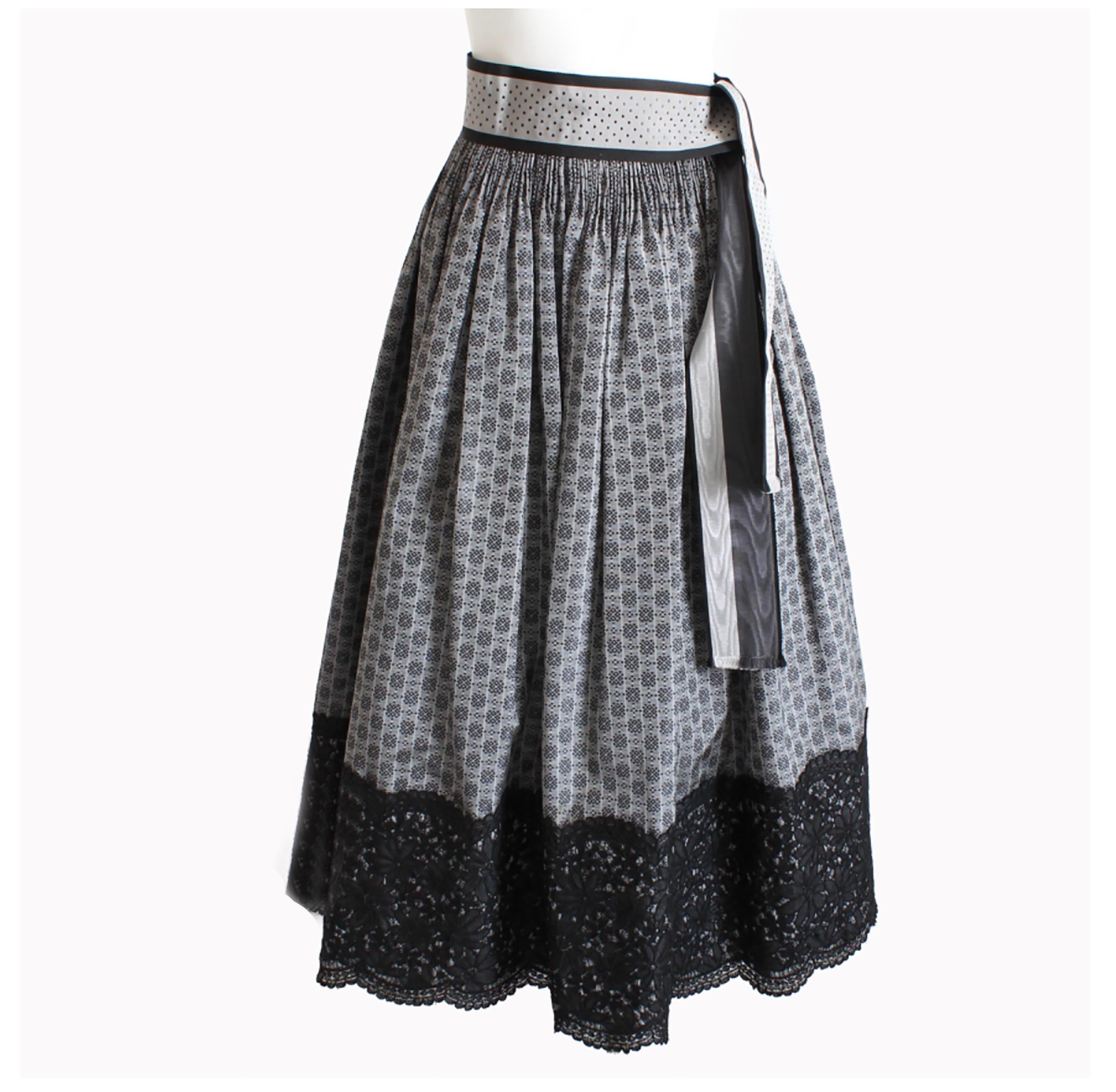 Gorgeous Geoffrey Beene floor length formal skirt with matching sash belt, likely made in the late 70s.  Made from what we believe is a silk blend taffeta (no content label) in an abstract dotted gray and black print, it has a shirred waist and