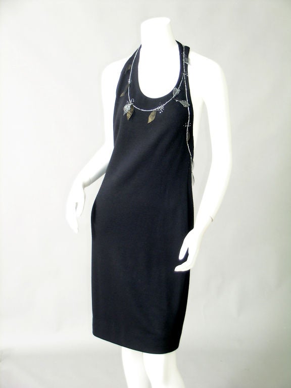 Super slinky and super sexy from Geoffrey Beene this little black dress is trimmed with delicate beadwork and metallic mesh leaves.  They circle the neckline and the left armhole adding extra interest to the unusual cut of the dress.
Mr Beene has