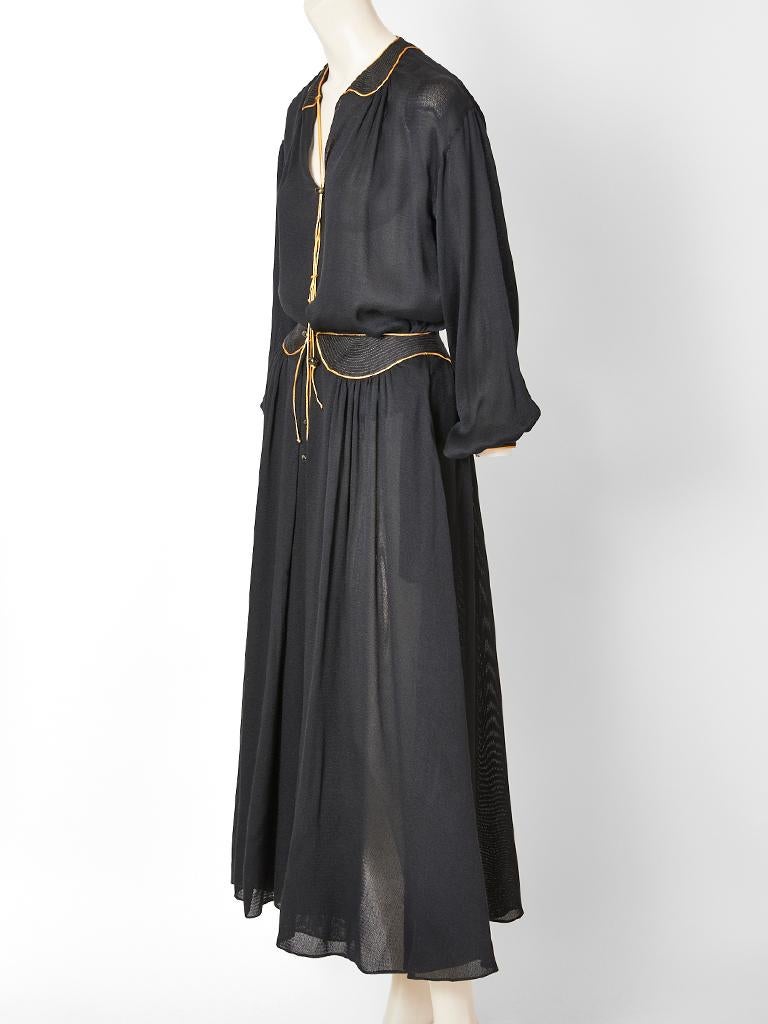 Geoffrey Beene, black, semi sheer, silk, skirt and blouse ensemble with gold details. Blouse is peasant style, having a v neckline with a peter pan collar that has gold stitching and tassel embellishment with balloon sleeves  and a dropped shoulder.