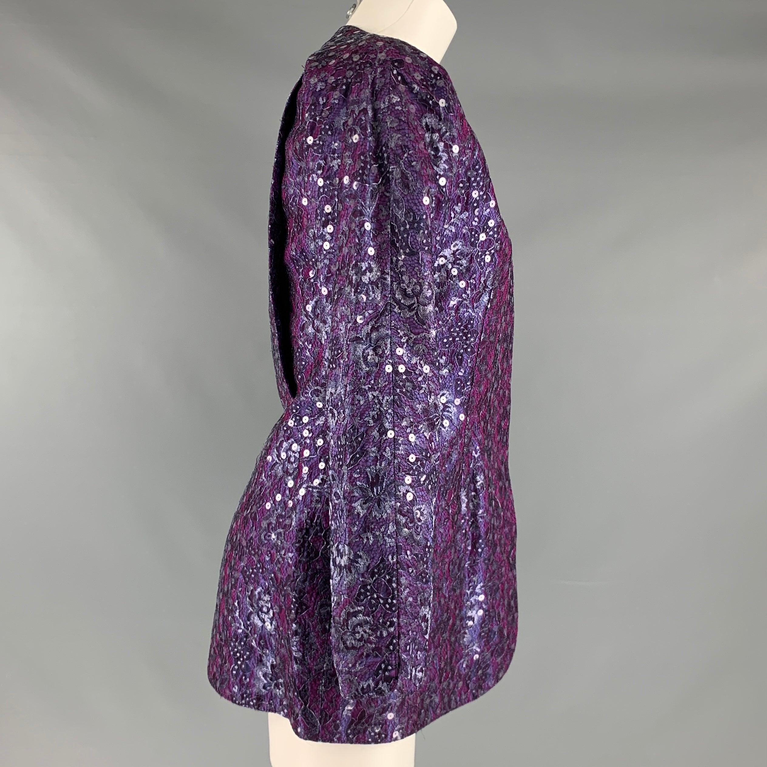 GEOFFREY BEENE blazer comes in a purple and silver lace material featuring flap pockets, collarless style, hidden packet and button up closure.Excellent Pre-Owned Condition. 

Marked:   M 

Measurements: 
 
Shoulder: 16 inches Bust: 37 inches