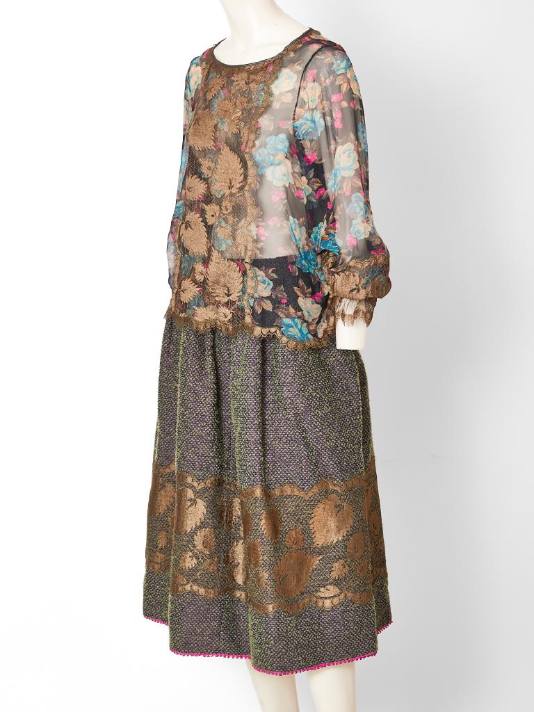 Geoffrey Beene, skirt and blouse ensemble, having a sheer, silk georgette, long sleeve top in a floral pattern with a scalloped hem and an iridescent gathered wool skirt. Both top and skirt are embellished with lace appliqués.