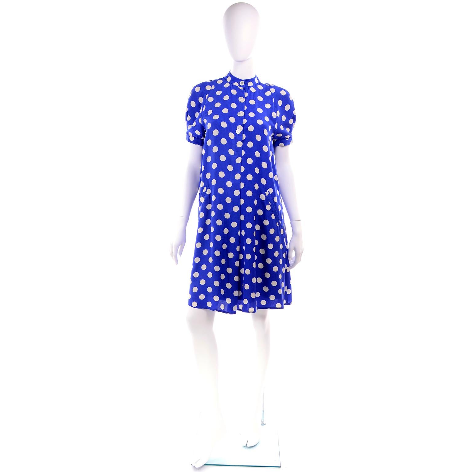 This is a lovely Geoffrey Beene vintage silk dress in a beautiful shade of royal blue with white polka dots.  The dress is similar to a tent dress, but not quite as full, and it has buttons in the front and side slit pockets.  There is a built in