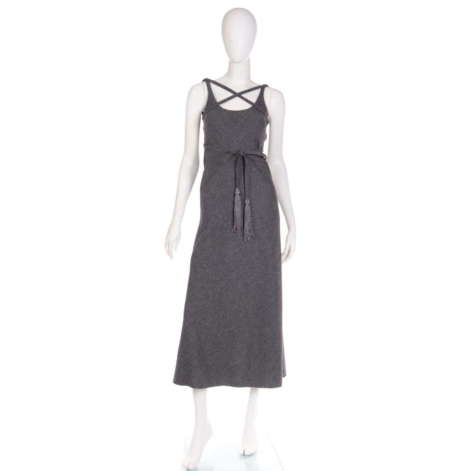Leave it to Geoffrey Beene to make an otherwise simple grey wool dress so interesting and chic! This vintage late 1960's or early 1970's Geoffrey Beene dress has a long thin fabric belt that can be tied in numerous ways to create a variety of unique