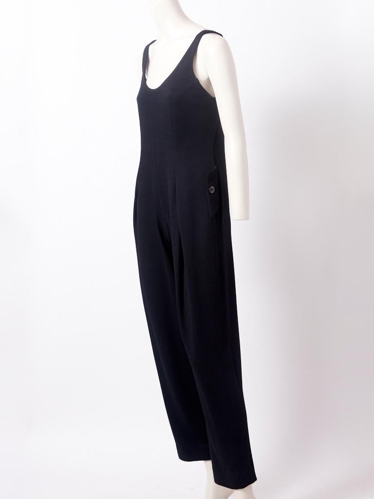 Geoffrey Beene, sleeveless, wool knit, jumpsuit, having a deep, scoop neck, semi fitted bodice and   button pocket detail at the hips.