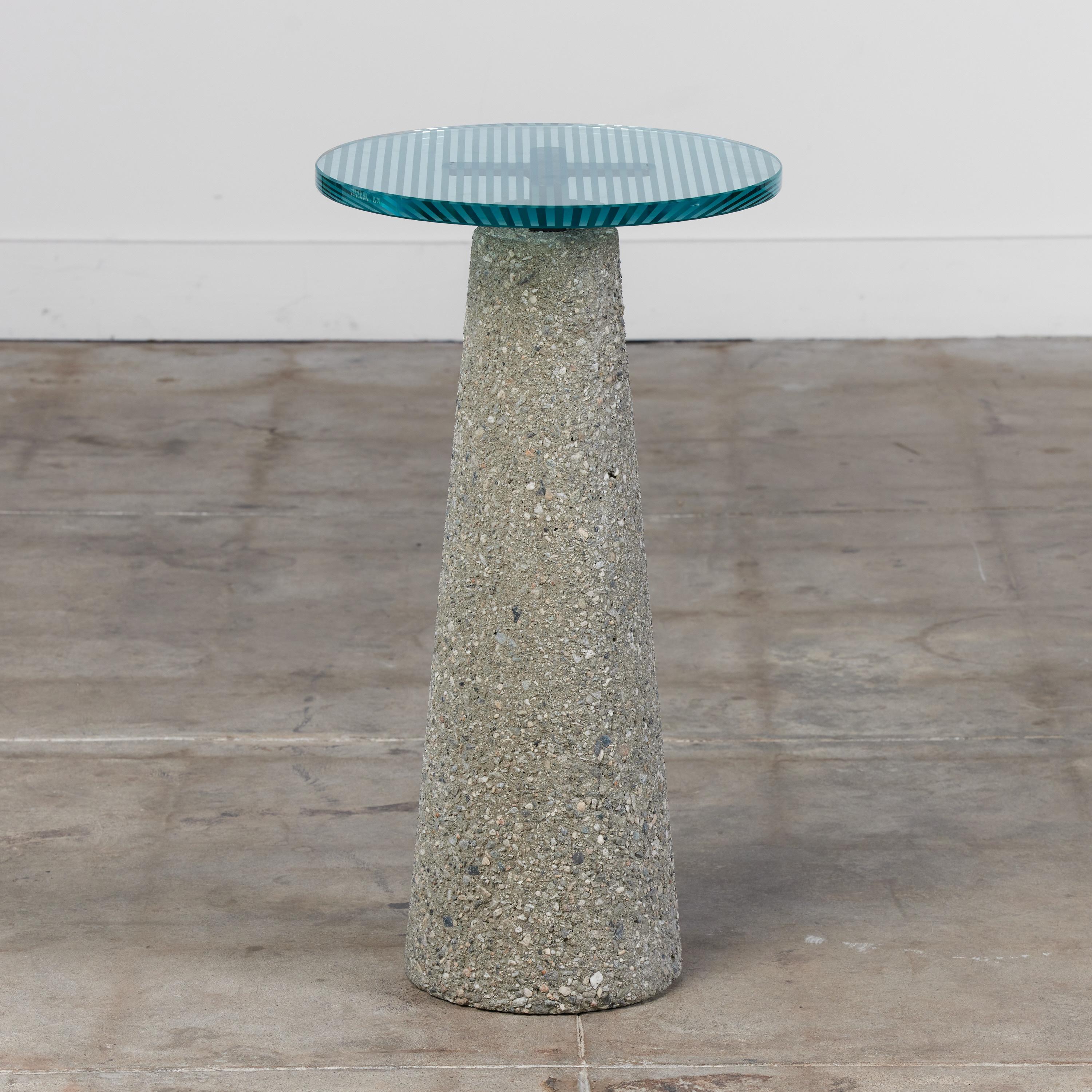 Pedestal by Geoffrey Frost c.1985, USA. This pedestal features an aggregate concrete tapered base with linear etched glass top. The round glass top is supported by a metal 
