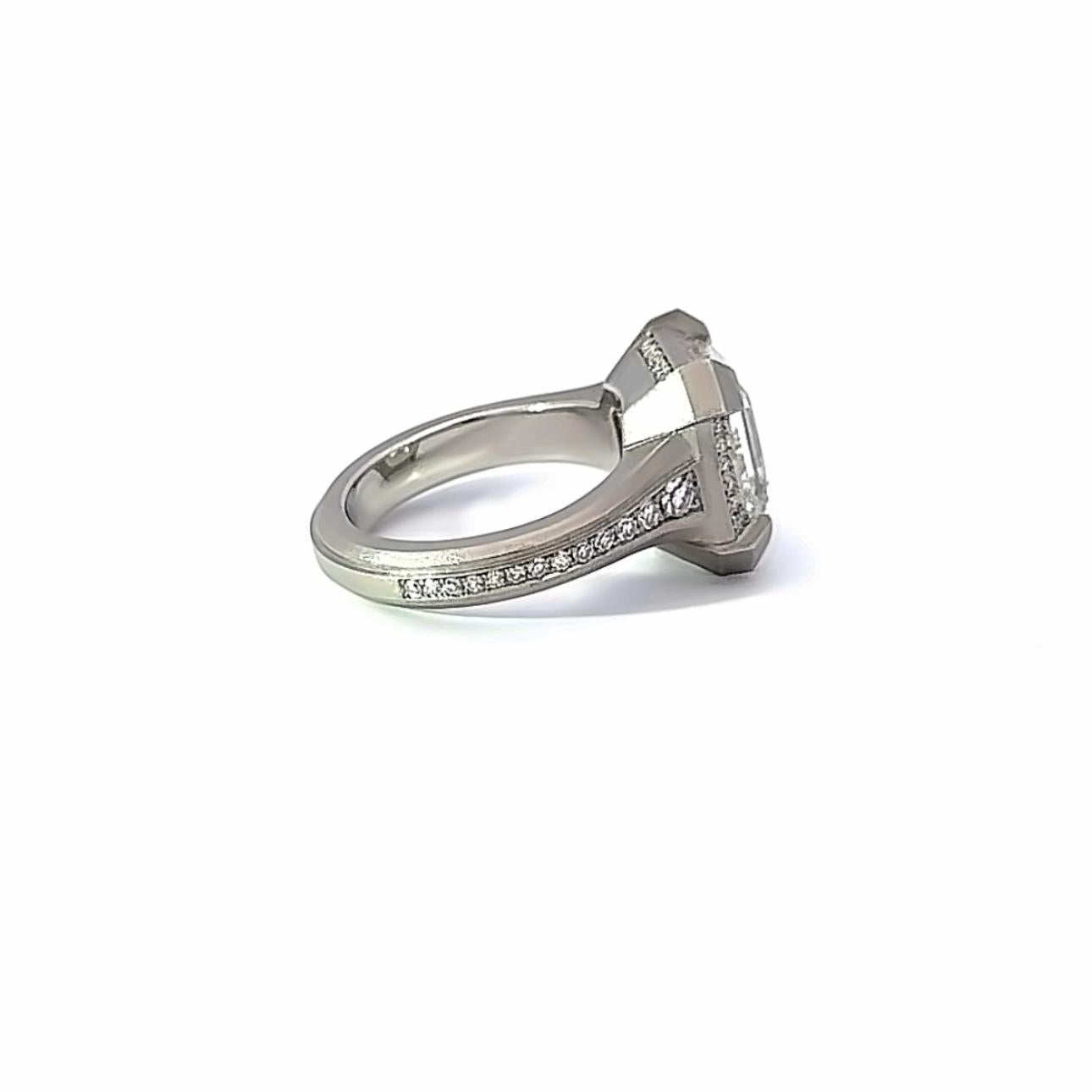 An architecturally powerful yet sleek diamond statement ring from Geoffrey Good.

Featuring a single GIA-certified natural Asscher Cut Diamond of 6.01 carats, mounted in our exclusive émerge-style setting and accented by an additional .49 carats of