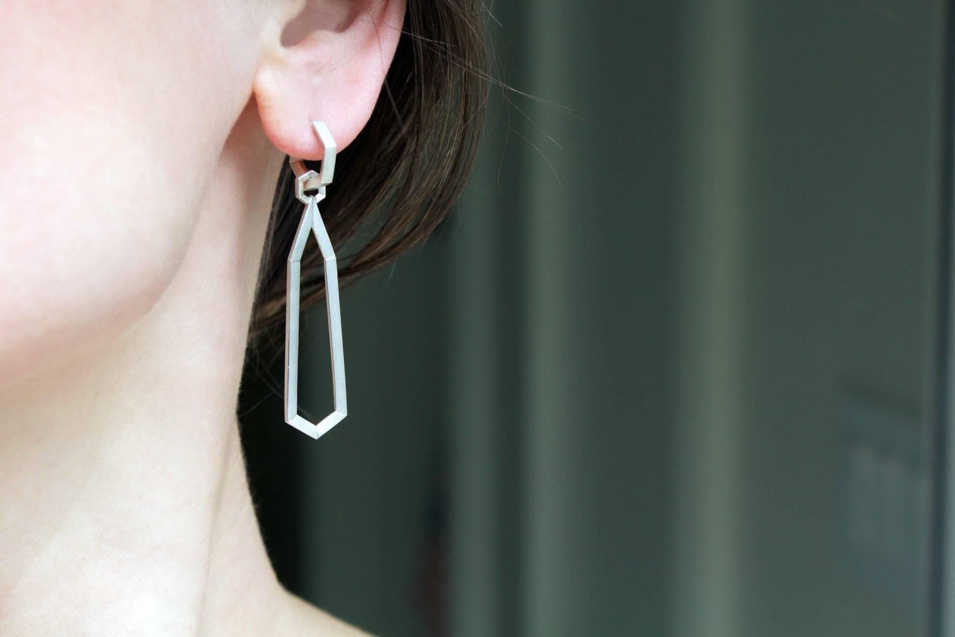 Two Earrings in one! Hex Day and Night Earrings handcrafted by renowned jewelry designer Geoffrey Good in satin-finished sterling silver showcasing a pair of detachable, elongated hexagonal drop elements 
attached by a hex-shaped jump-ring to a pair