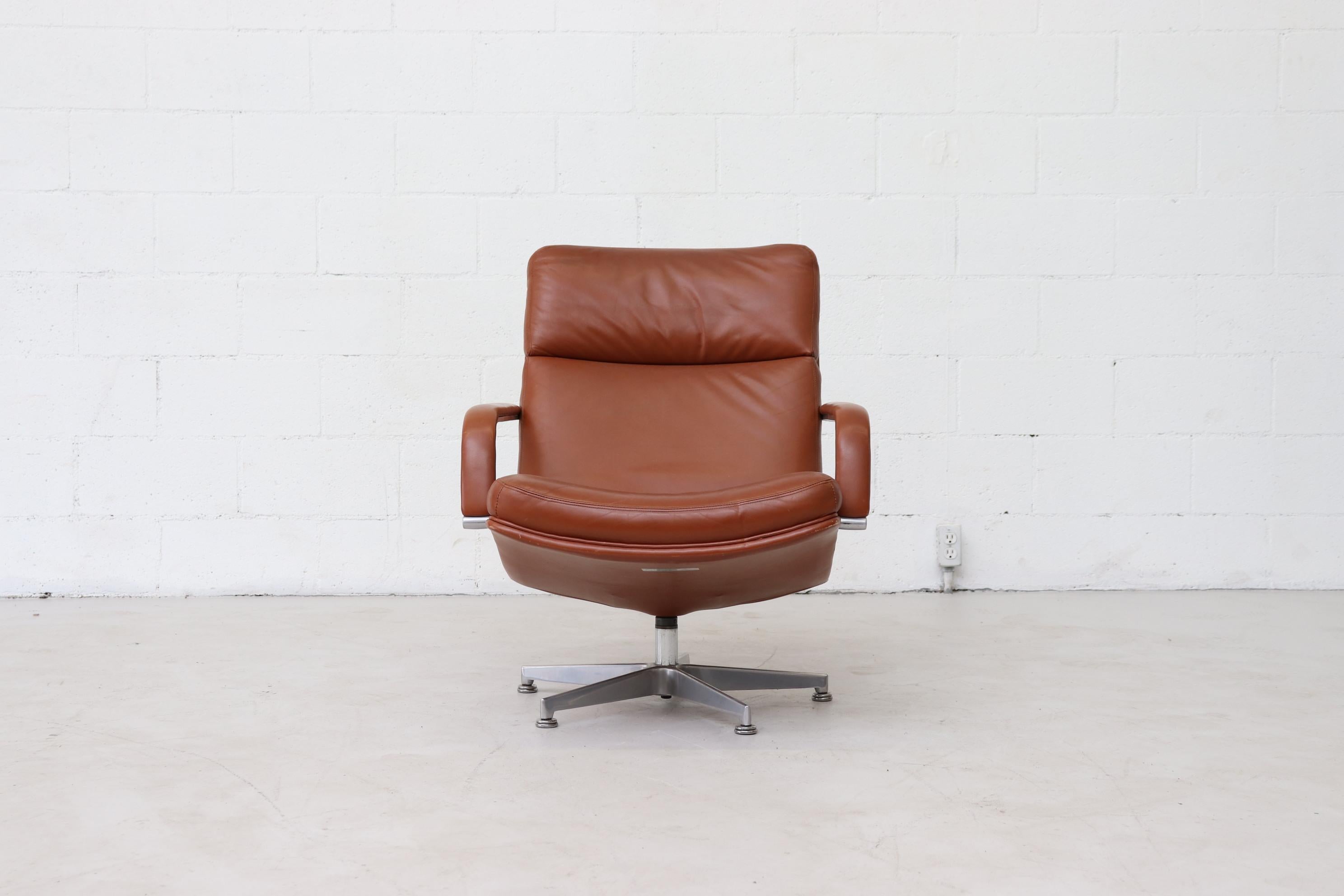 Impressive red cognac leather armchair with metal frame by Geoffrey Harcourt. The stylish cognac leather covers both of the arms as well as the bottom and back of chair. Original Artifort Production label on bottom. Good overall original condition