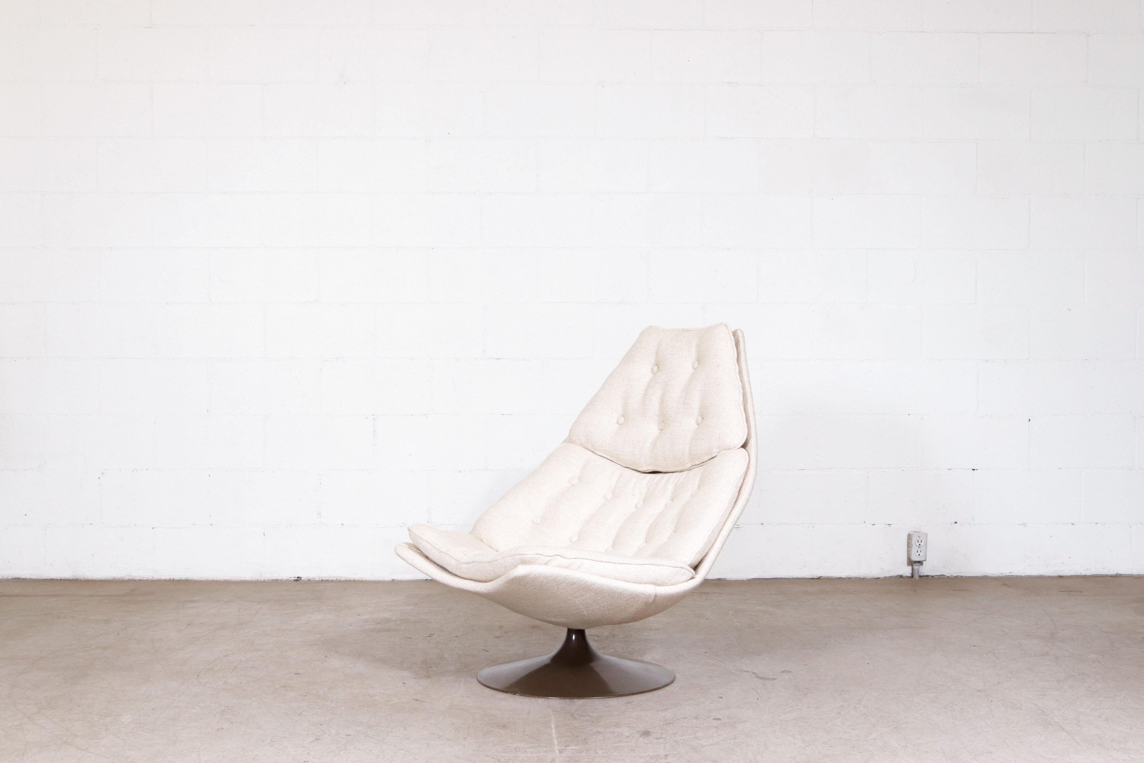Beautiful 1967 Geoffrey Harcourt 'F588' Swivel lounge chair for Artifort. In impressive overall condition with new oatmeal fabric and original brown enameled metal trumpet base. Wear is consistent with it's age and use.