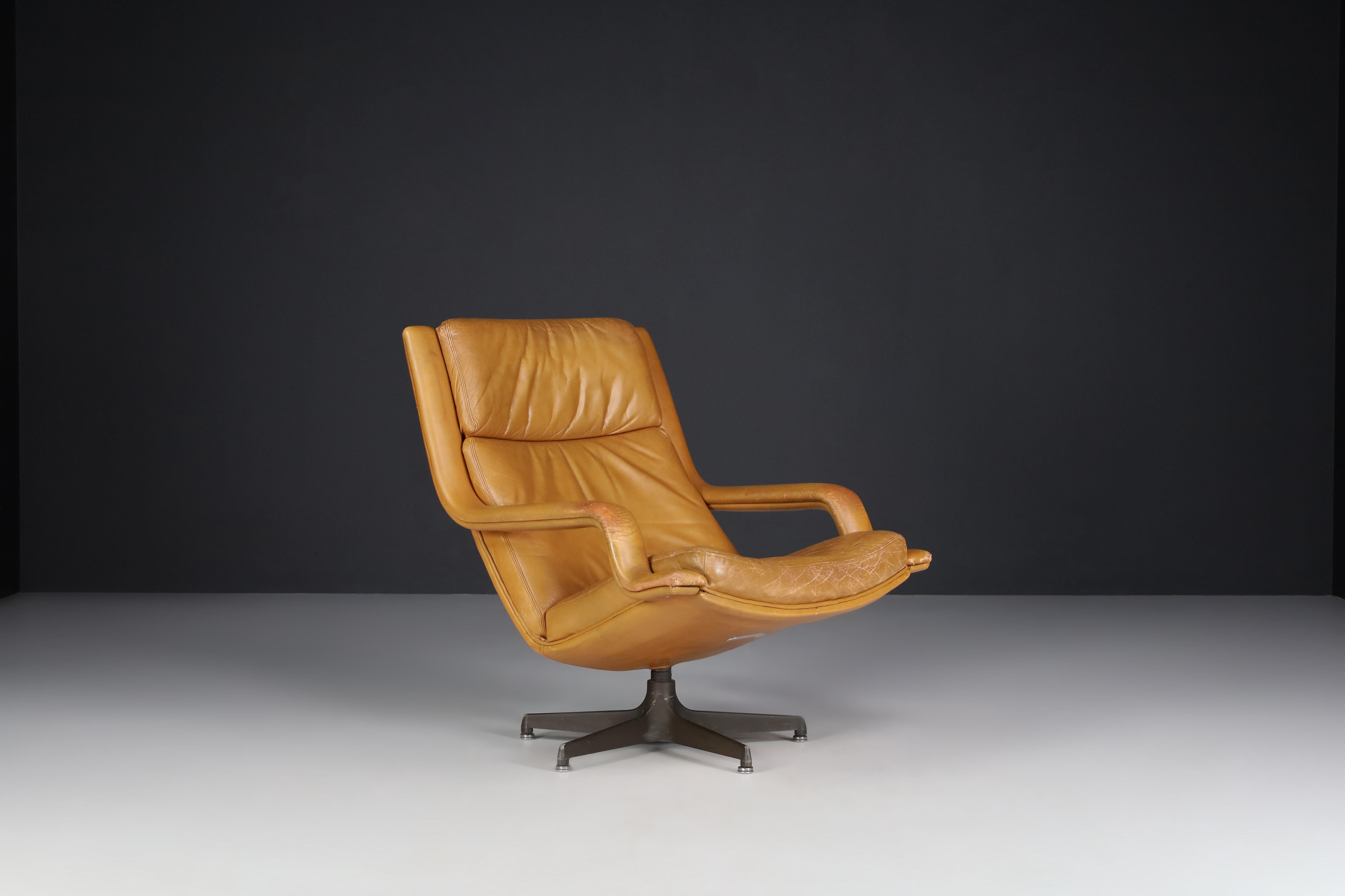 Geoffrey Harcourt Patinated Cognac Leather Swivel Lounge Chair, The Netherlands 1970s

Patinated cognac leather Artifort F141 Swivel lounge chair designed by Geoffrey Harcourt mid-1970s. In beautiful patinated cognac leather upholstery with a
